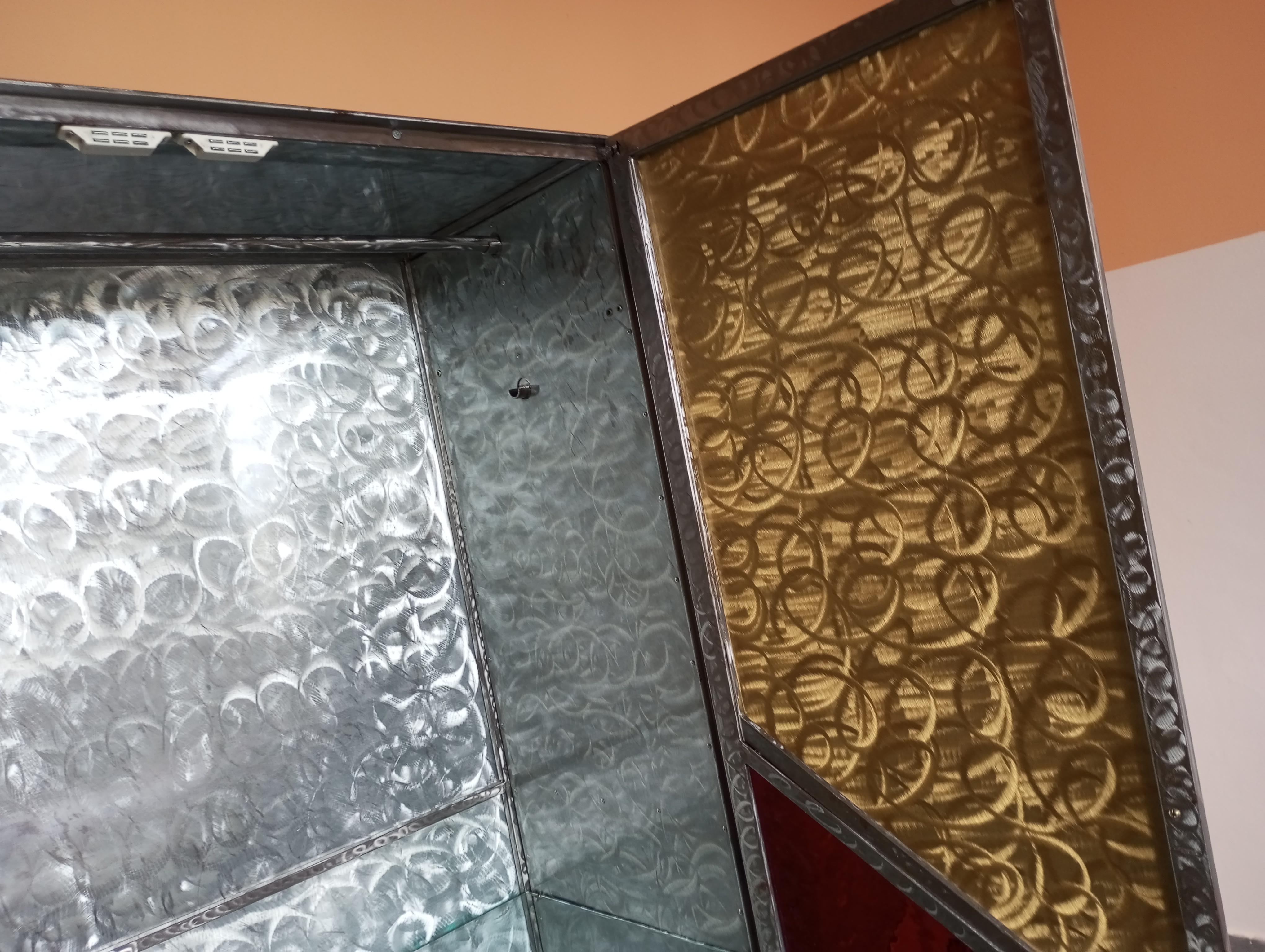Aluminum Four-door sculpture cabinet with glass shelves Italy 1970s/80s For Sale