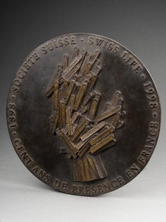 Arman (after) : "La main tendue", Patinated bronze medallion, 1998
