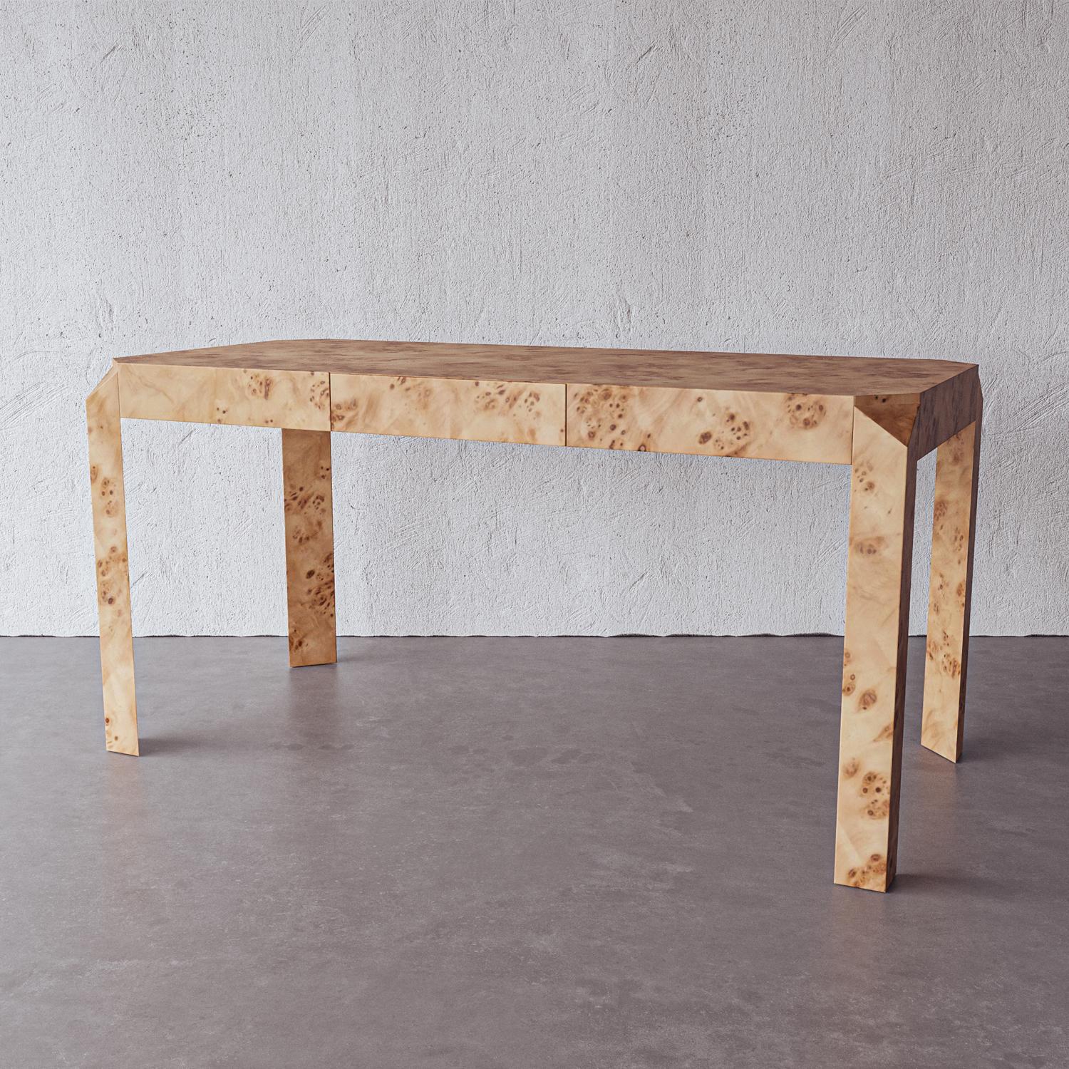 The first ready-to-assemble desk from Lemieux et Cie features angular cut corners and ample surface space for use as a table, console or vanity. A single hidden drawer adds storage space to keep your table surface organized. Handmade by artisans in