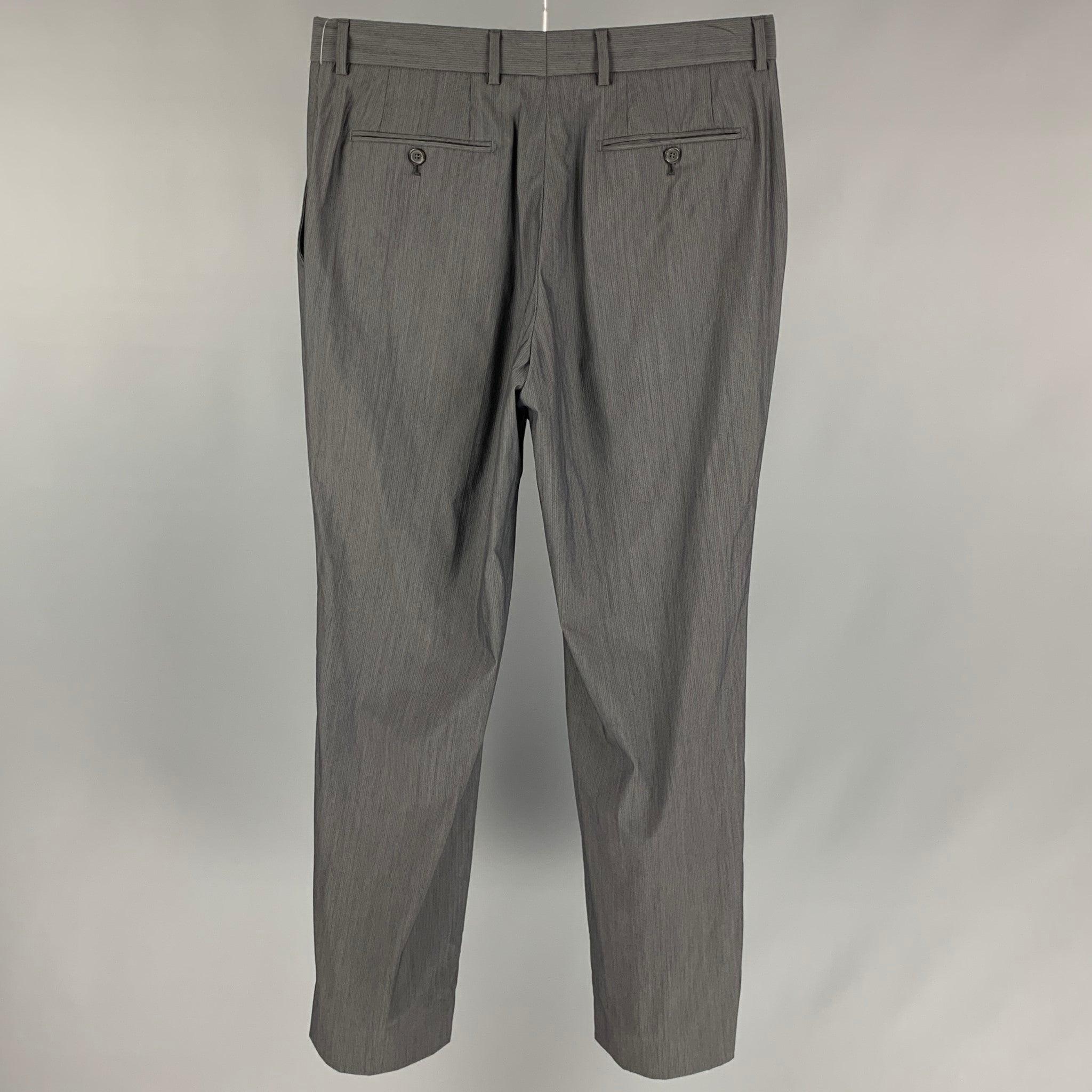 ARMAND BASI dress pants comes in a grey stripe wool blend featuring a flat front, straight leg, single button, and a zip fly closure.
 Very Good Pre-Owned Condition. 
 

 Marked:  EU 42 / UK 32 / US 32 
 

 Measurements: 
  Waist: 32 inches Rise: