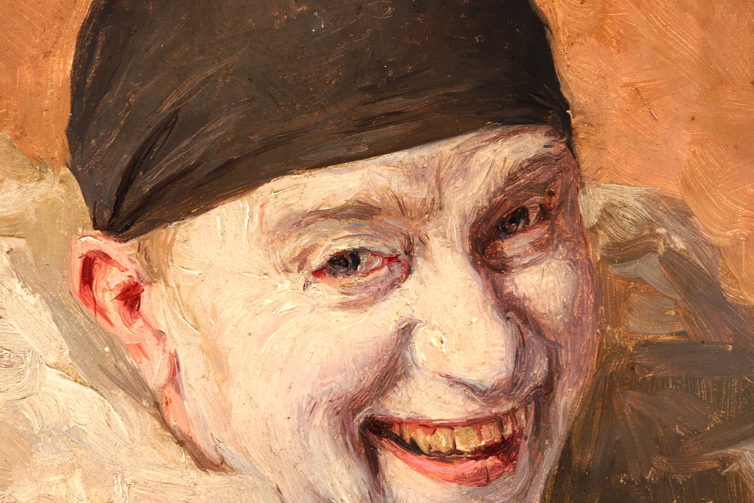 A charming oil on panel circa 1900 by French impressionist painter Armand Francois Henrion depicting a portrait of a happy Pierrot - a French clown - wearing white ruffles and a black hat. The portrait is contrasted by an orange-red