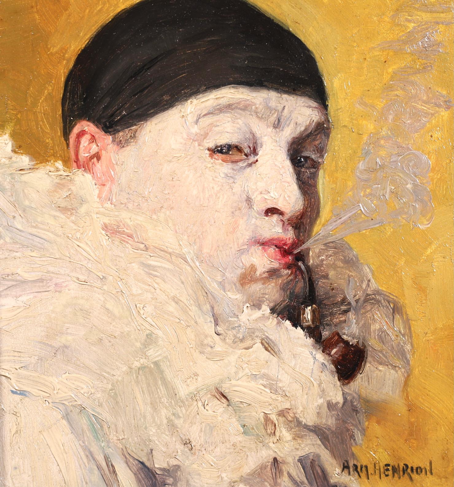 A charming oil on panel circa 1900 by French impressionist painter Armand Francois Henrion depicting a portrait of a Pierrot - a French clown - wearing white ruffles and a black hat smoking a wooden pipe. The portrait is set against a yellow-gold