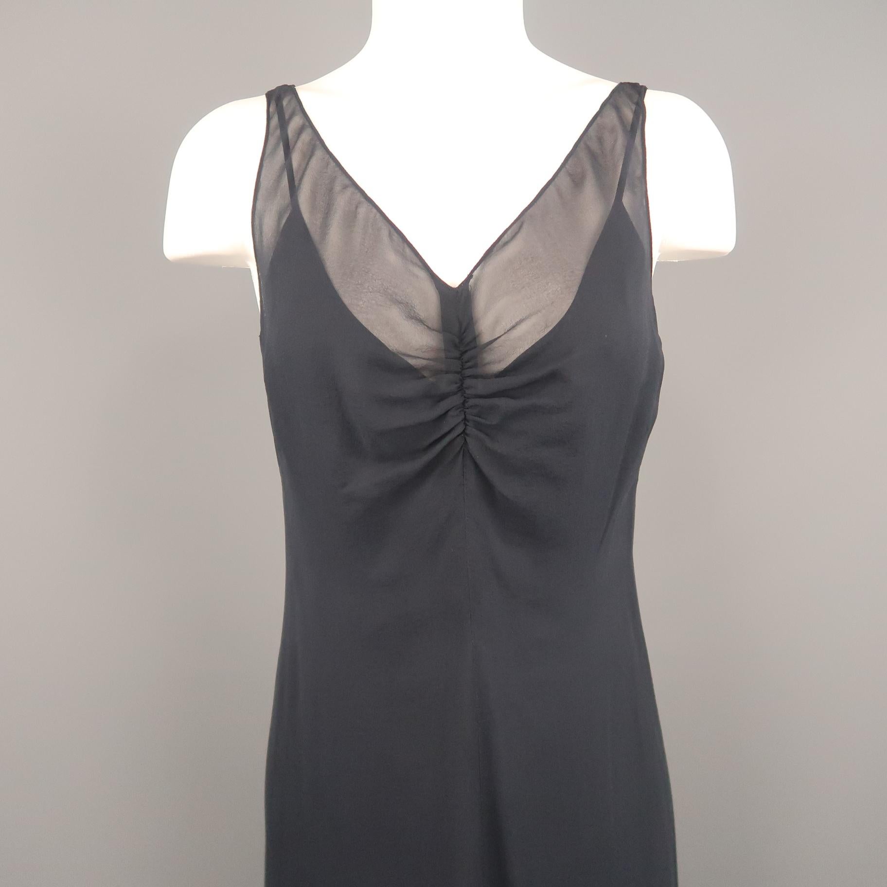 ARMAND VENTILO sleeveless maxi dress comes in navy silk chiffon with a deep V neckline, gathered front, A line silhouette and buttoned back. With slip.
 
Excellent Pre-Owned Condition.
Marked: IT 38
 
Measurements:
 
Bust: 36 in.
Waist: 32 in.
Hip: