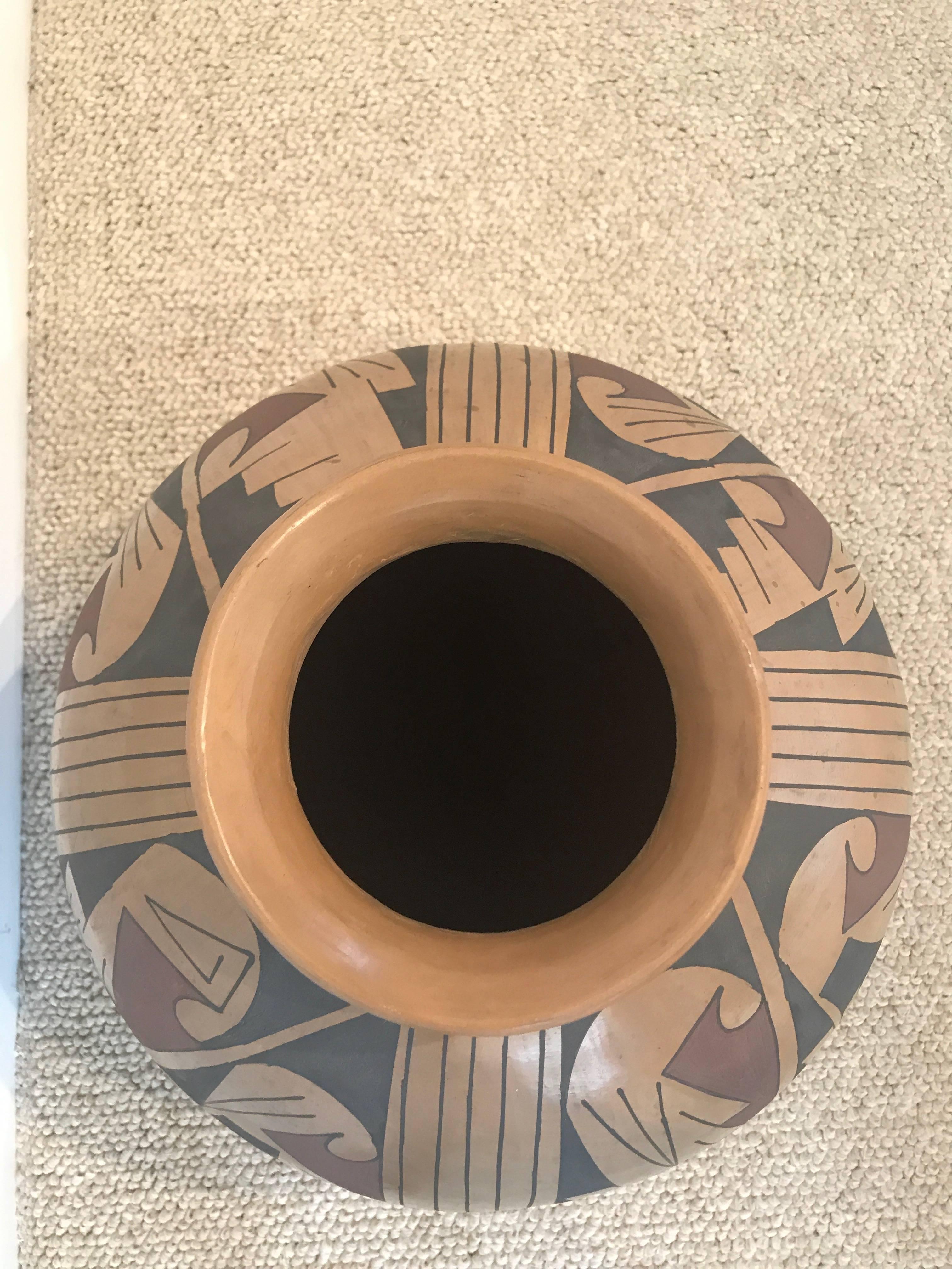 Stunning globular form on this striking piece with rounded base and slightly flared rim; linear geometrics interspersed with round elements decorate the body; signed on base, Armando Silveira.