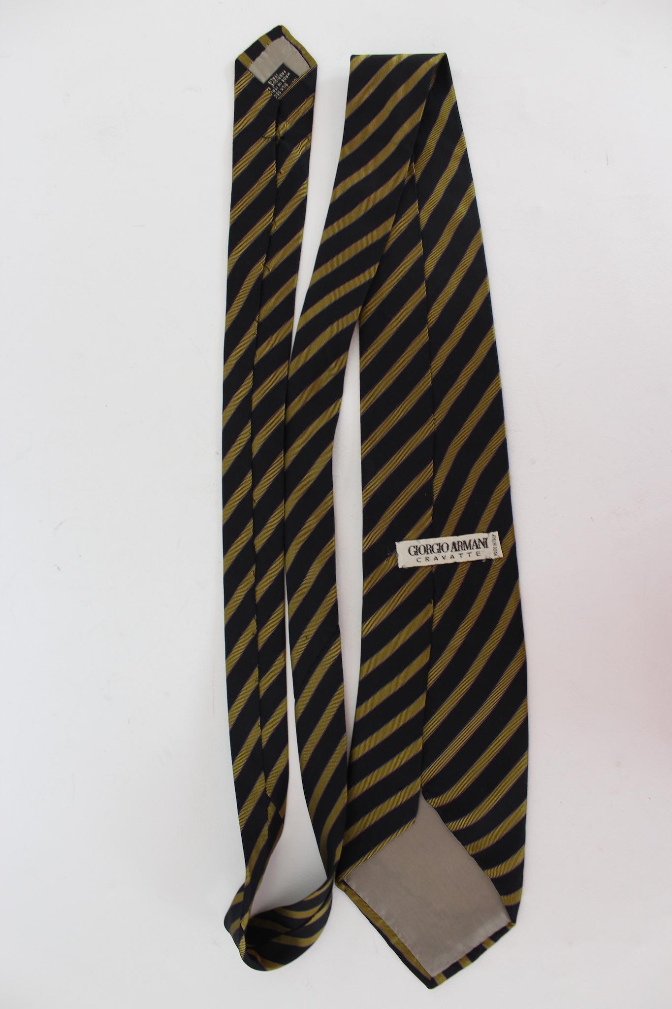 Cravate vintage Giorgio Armani des années 2000. Bleu et jaune, motif rayé. Tissu 100 % soie. Fabriquées en Italie.

Longueur : 150 cm
Largeur : 9 cm