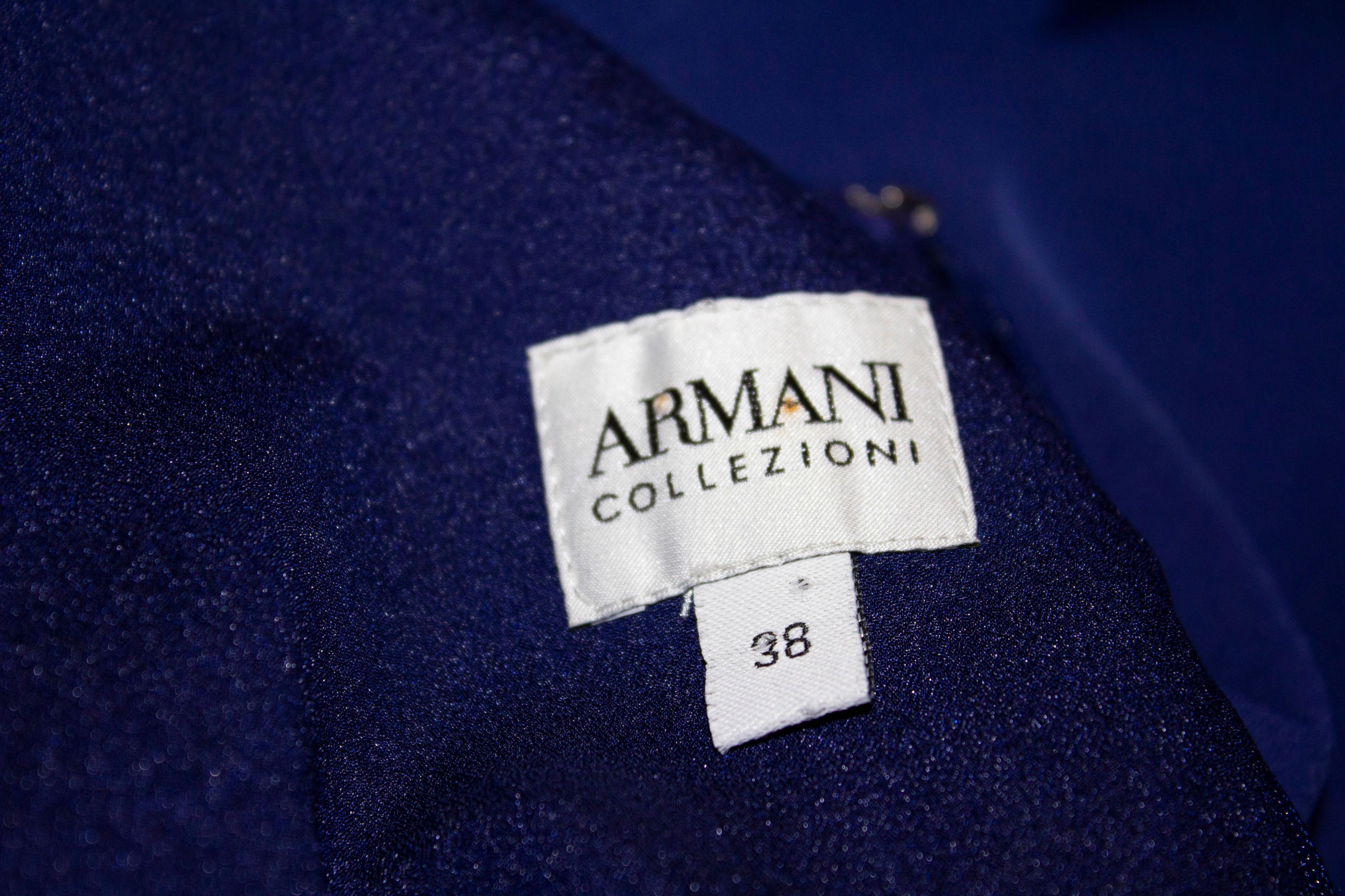 A chic  dress by Armani Colezzioni. The dress is in a wonderful shade of blue, with a round neckline, elbow length sleaves, gathering on the left hand side and a central back zip. It is lined and has shoulder pads. Size 38 Measurements: Bust 33'',