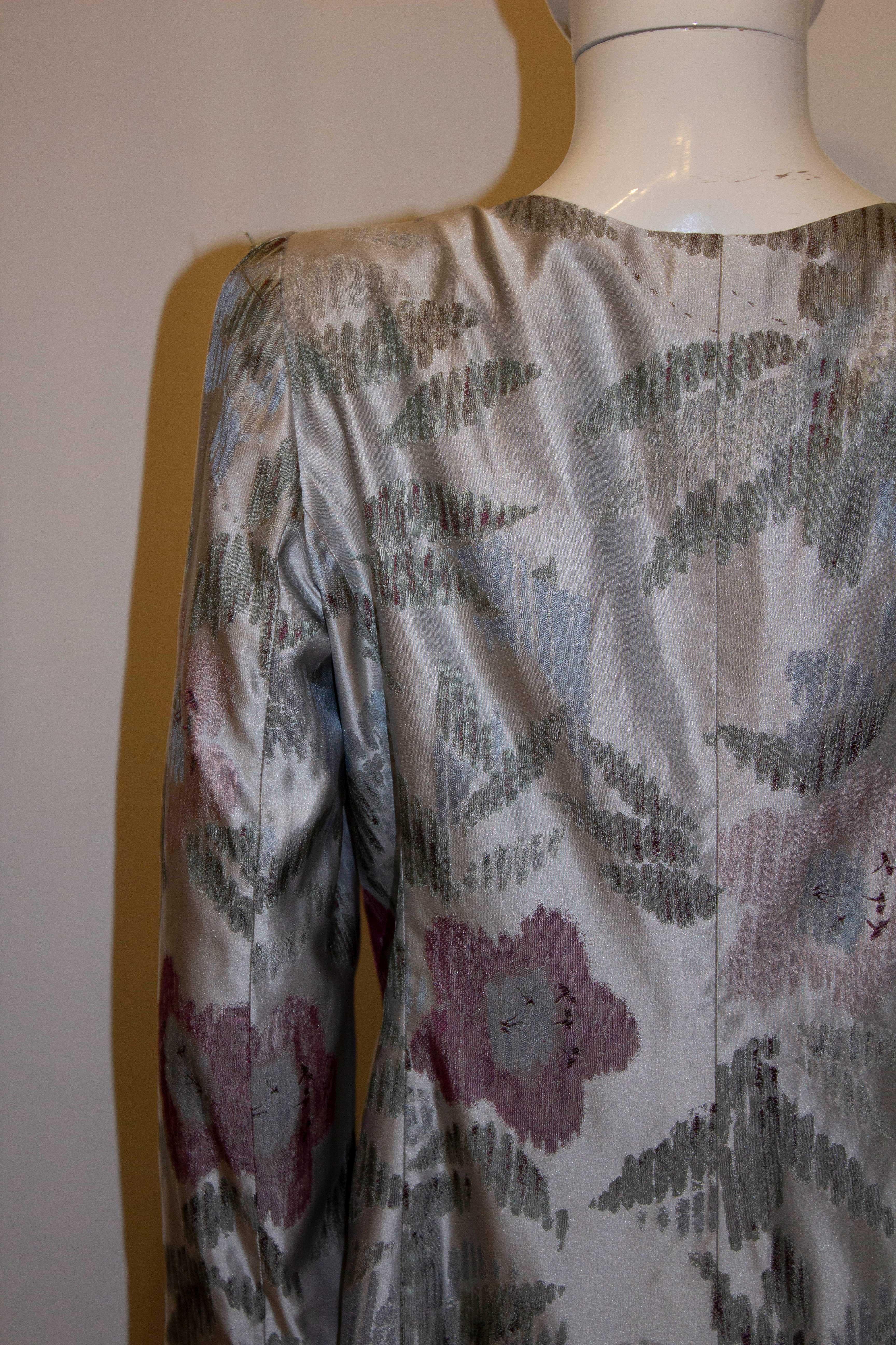 Une jolie veste de soirée de Armani Collezioni, dans un  gris, argent et rouge pint. La veste a une fermeture asymétrique avec des détails de volants. taille 46 Mesures : Poitrine 38'', longueur 24''