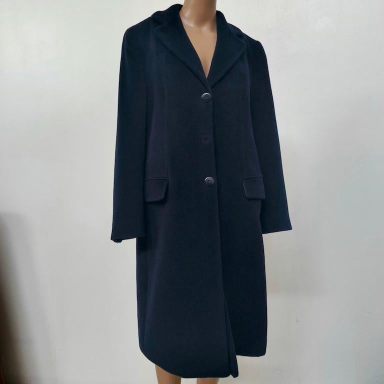 Slip into the quiet luxury that defined Armani Collezioni at the turn of the millennium. Tailored in Italy from a richly-textured wool–cashmere blend, this deep-midnight overcoat drapes with the fluid line and understated authority that made Giorgio