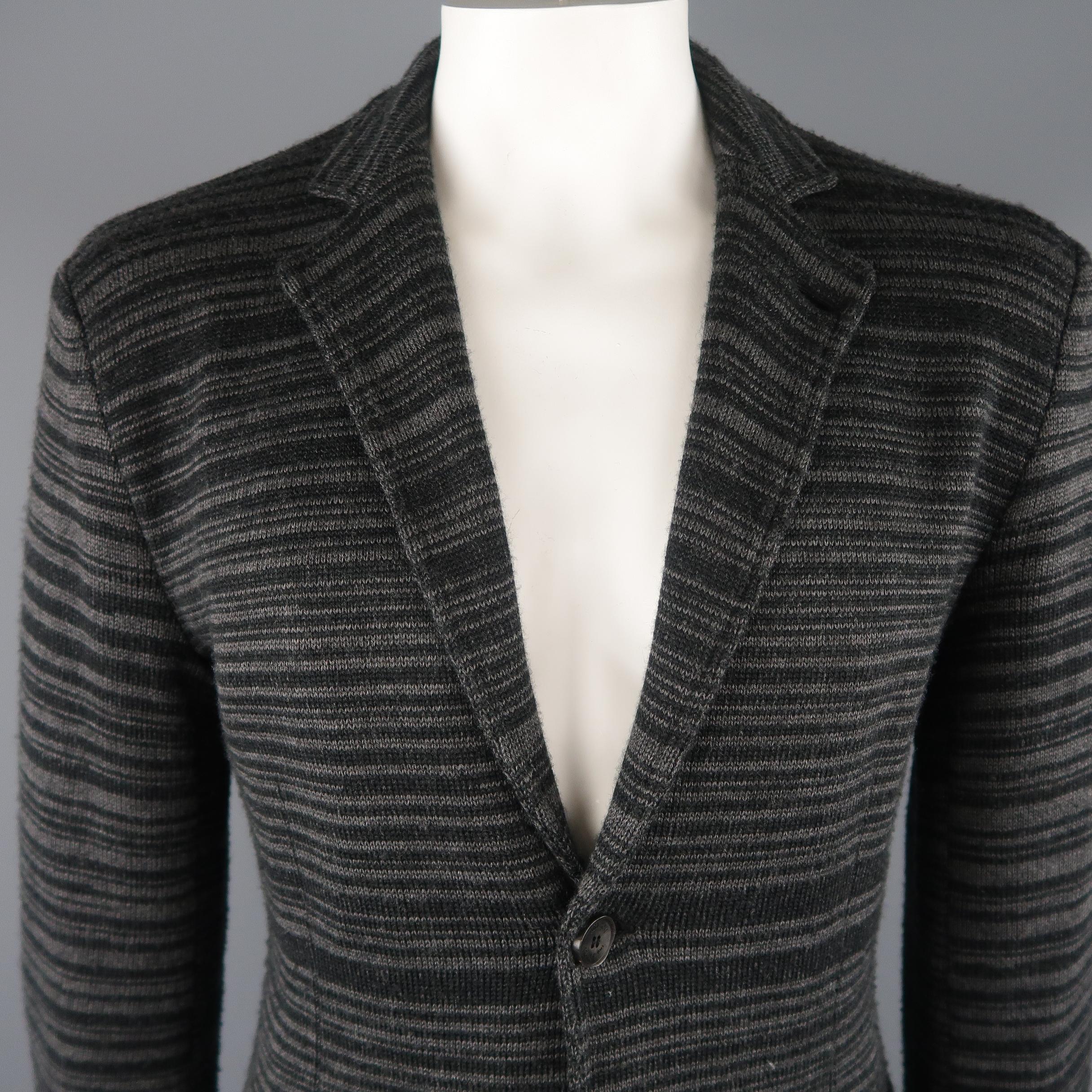ARMANI COLLEZIONI sport coat comes in black and gray tones in stripped knitted wool blend material, with a notch lapel, 2 buttons closure, single breasted, slit pockets, unlined. Made in Italy.
 
Excellent Pre-Owned Condition.
Marked: No size
