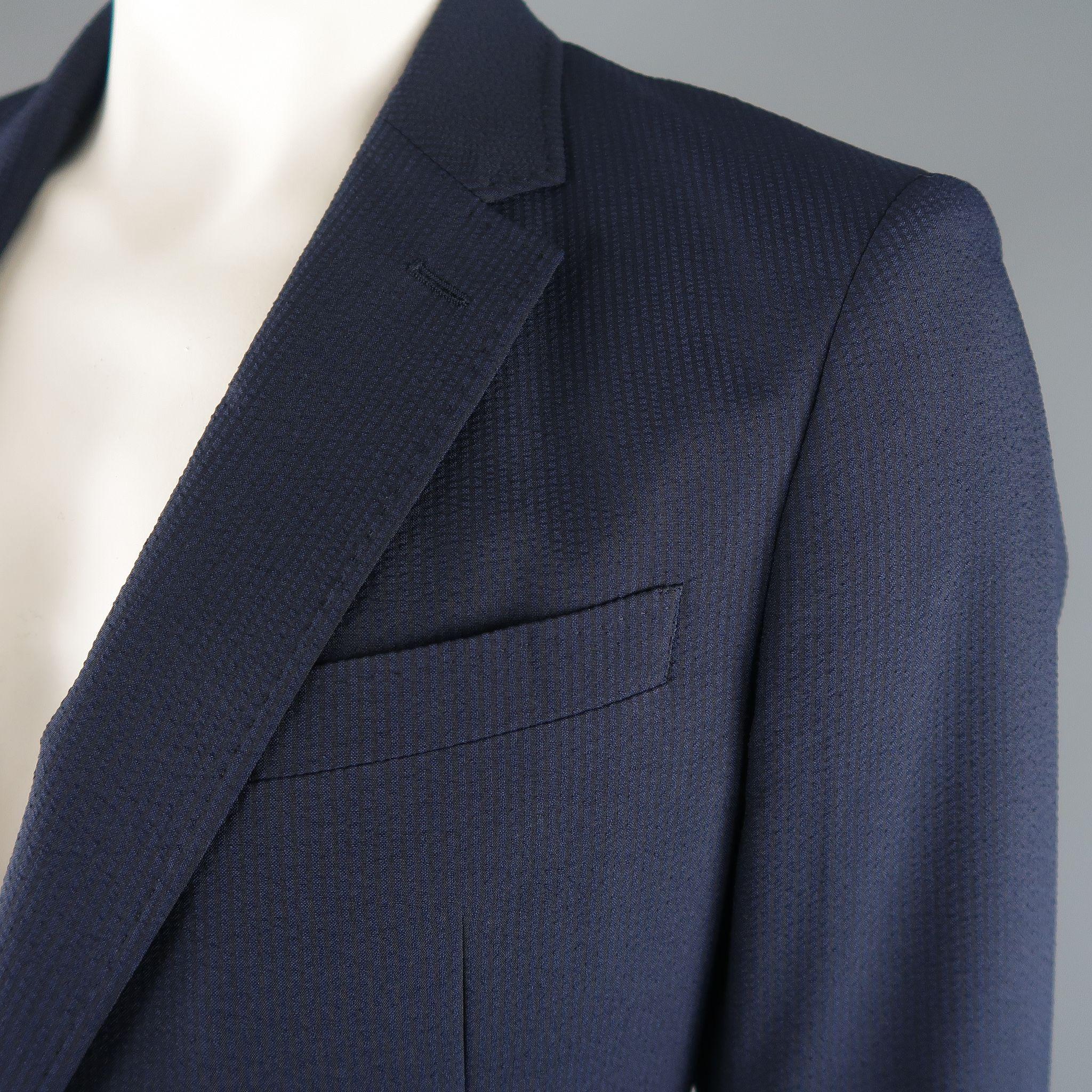 Single breasted ARMANI COLLEZIONI sport jacket comes in stripe textured fabric with a notch lapel, two button closure, and double vented back.

Excellent Pre-Owned Condition.
Marked: 44 R

Measurements:

l Shoulder: 18 in.
l Chest: 46 in.
l Sleeve: