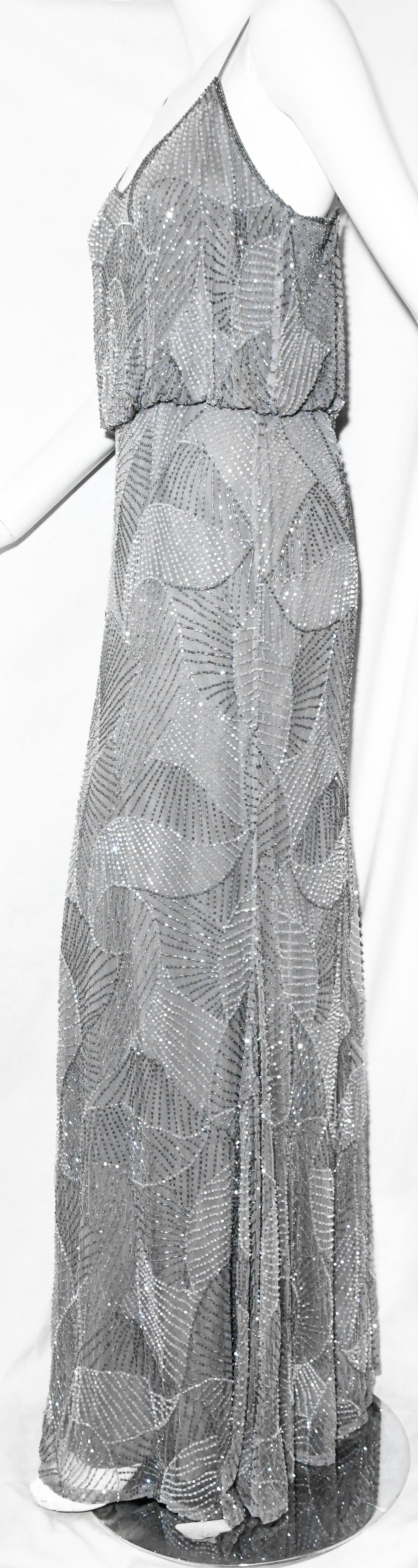 Armani Collezioni beaded grey gown in shell design embroidered throughout. With V neckline and spaghetti straps this blouson bodice and bias cut column skirt will stand out at your event.  For closure, a zipper at the back.   This gown is