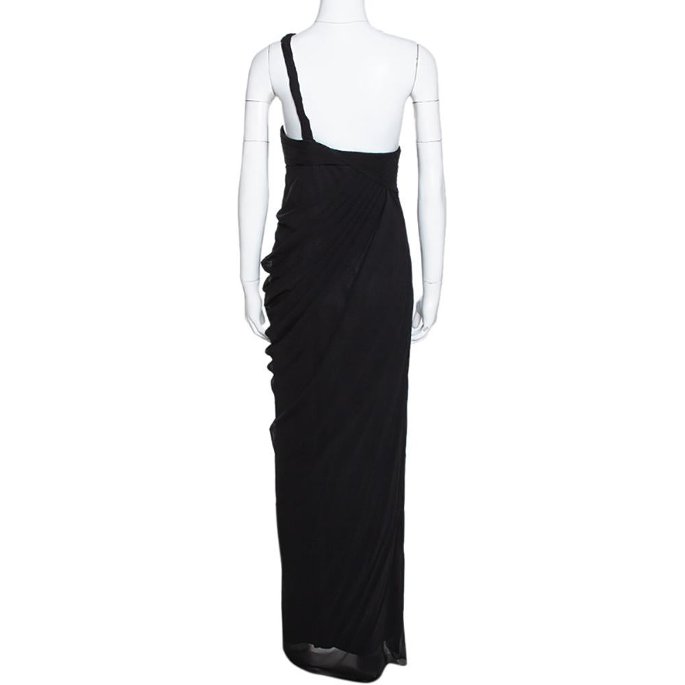 You're all set to cast a spell on the crowds in this dress from Armani Collezioni! The black creation is made of 100% silk and features an asymmetric shoulder detail. It comes equipped with a concealed zip closure. Pair it with metallic stilletoes