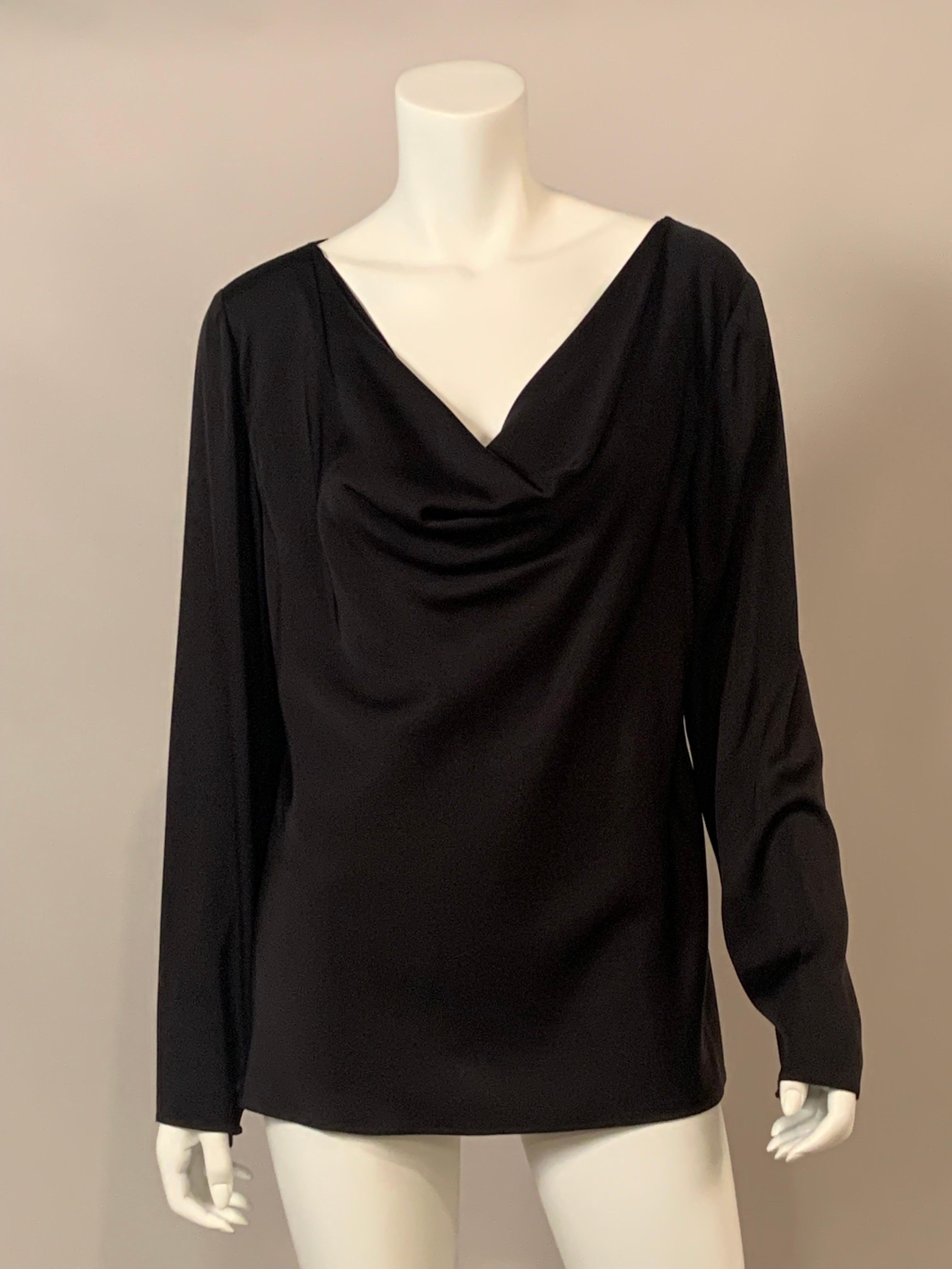 An elegant black silk tunic from Giorgio Armani has a draped and weighted neckline which adds elegance and polish to this black top. The long sleeves have invisible zippers at the wrists.  It is marked a 1980's size 16 which is a contemporary size