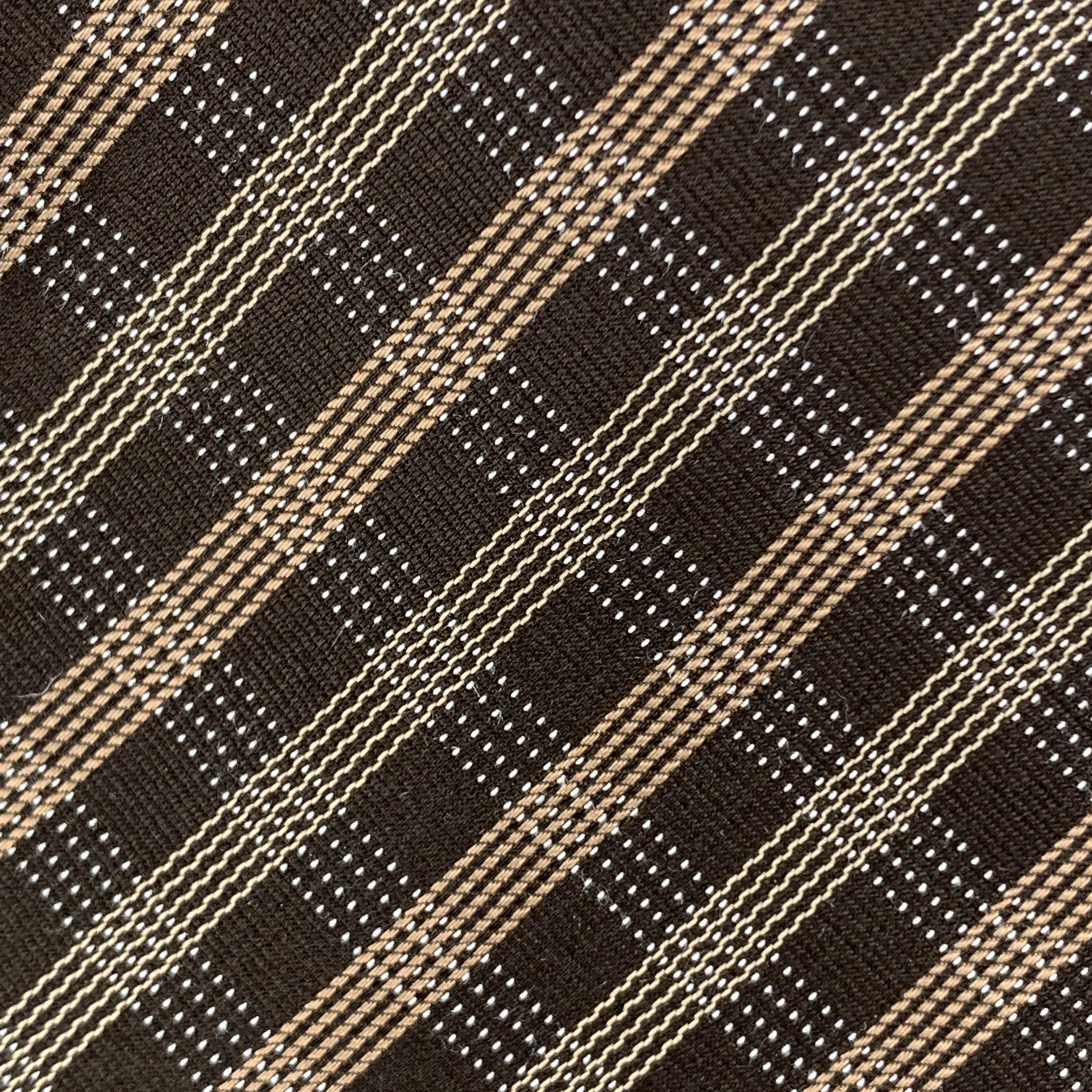 ARMANI COLLEZIONI necktie comes in brown silk with all over plaid print. Made in Italy.

Excellent Pre-Owned Condition.

Width: 3 in.