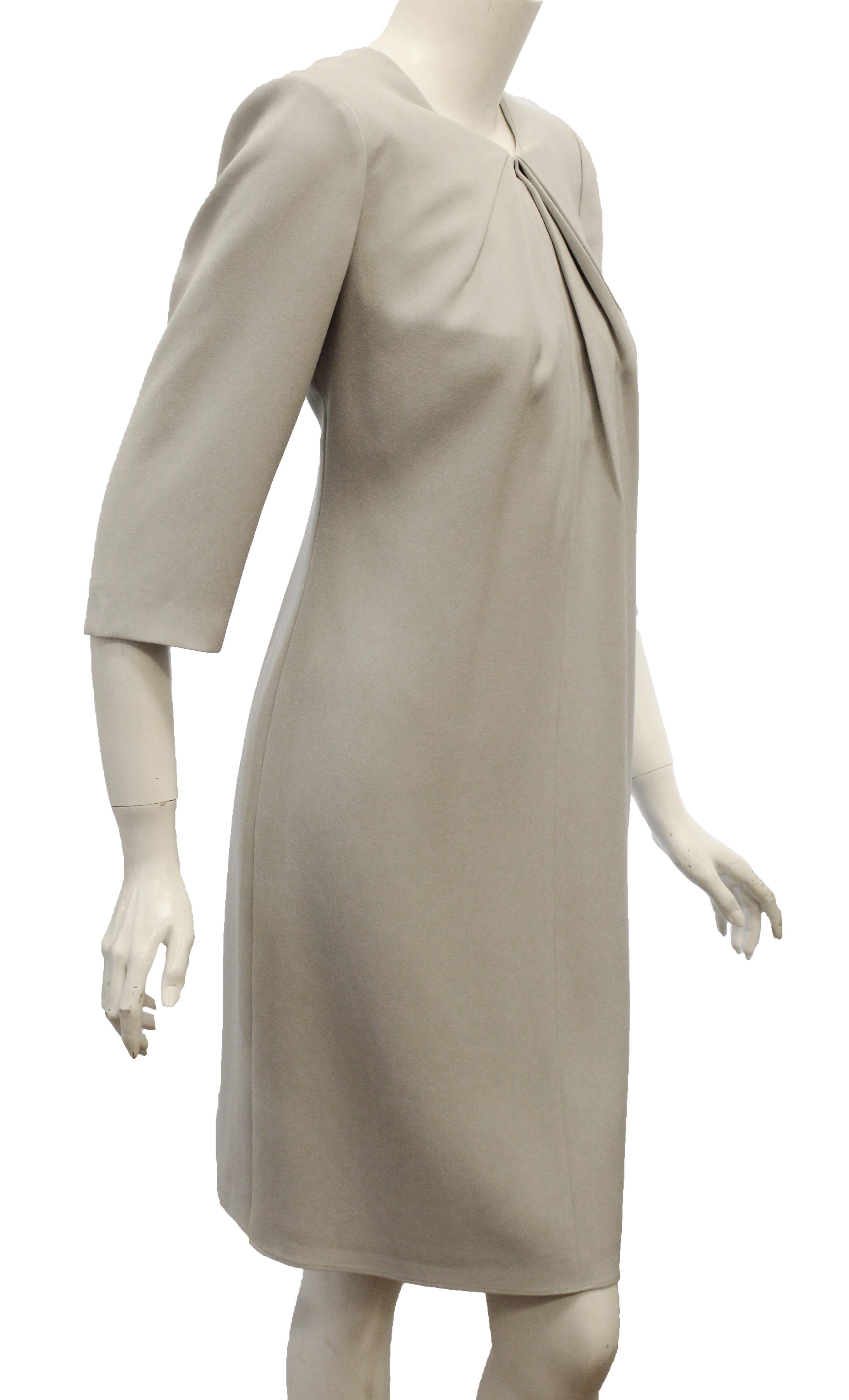 Armani Collezioni grey jersey with ruched collar dress includes a slit keyhole at front.  This  3/4 sleeve sheath knee length dress is perfect for all seasons by just adding a jacket, a scarf or a coat.   This dress is fully lined and in excellent