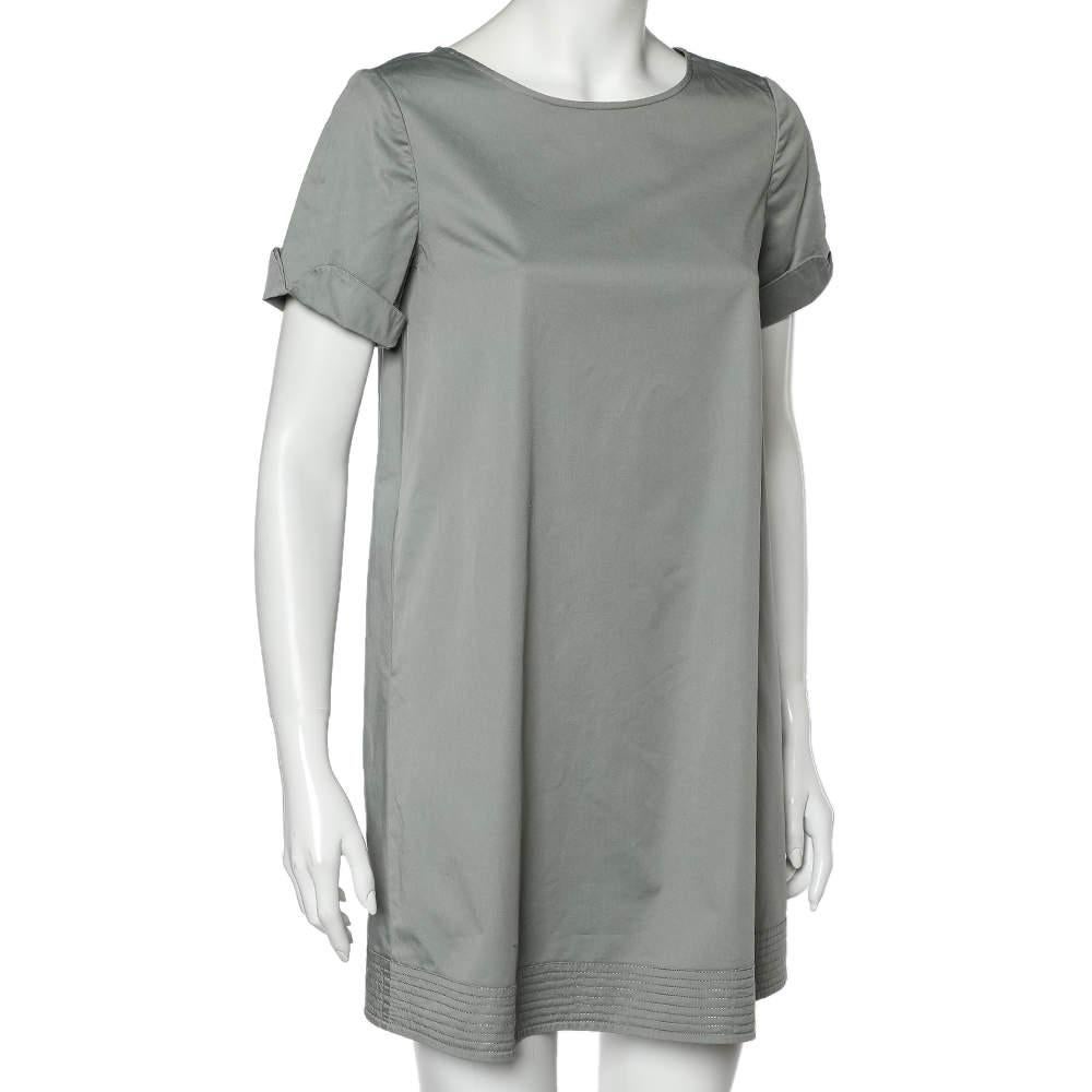 Effortlessly made into a chic design, this Armani Collezioni dress is easy to wear and easy to accessorize. Tailored beautifully, the dress has a simple neckline, short sleeves, and a quilted hem. It is sure to remain a favorite season after season.