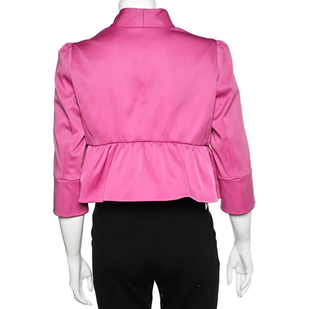 Appear pretty in pink as you flaunt this jacket from the House of Armani Collezioni. It has been tailored using pink sateen fabric and is highlighted by a ruffled detailing and a cropped style. It is provided with a hook closure. Complement this