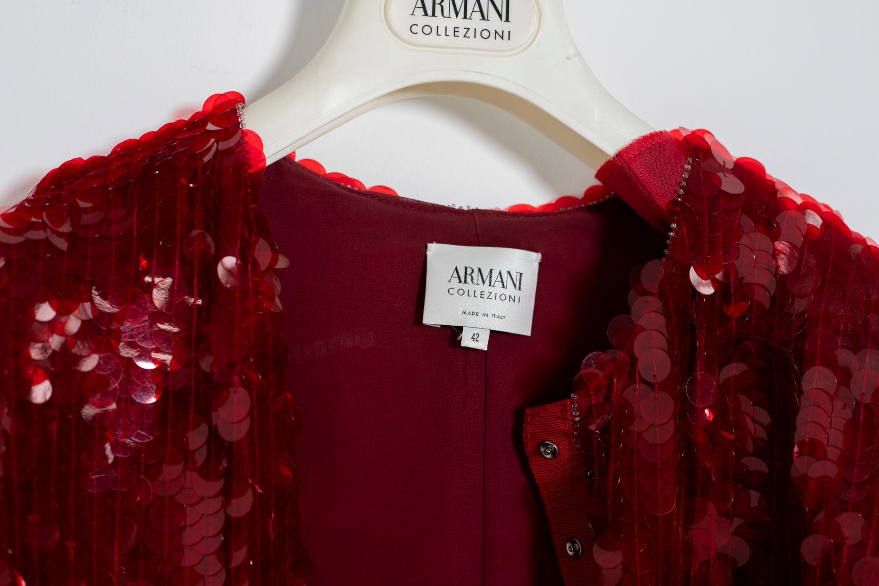 Jacket or Blazer by Armani Collezioni from the 2000s.
The jacket has a dark red silk lining. Its particularity is its great workmanship with hand-stitched sequins applications in red colour. Click closure.  Great Italian craftsmanship. Evening