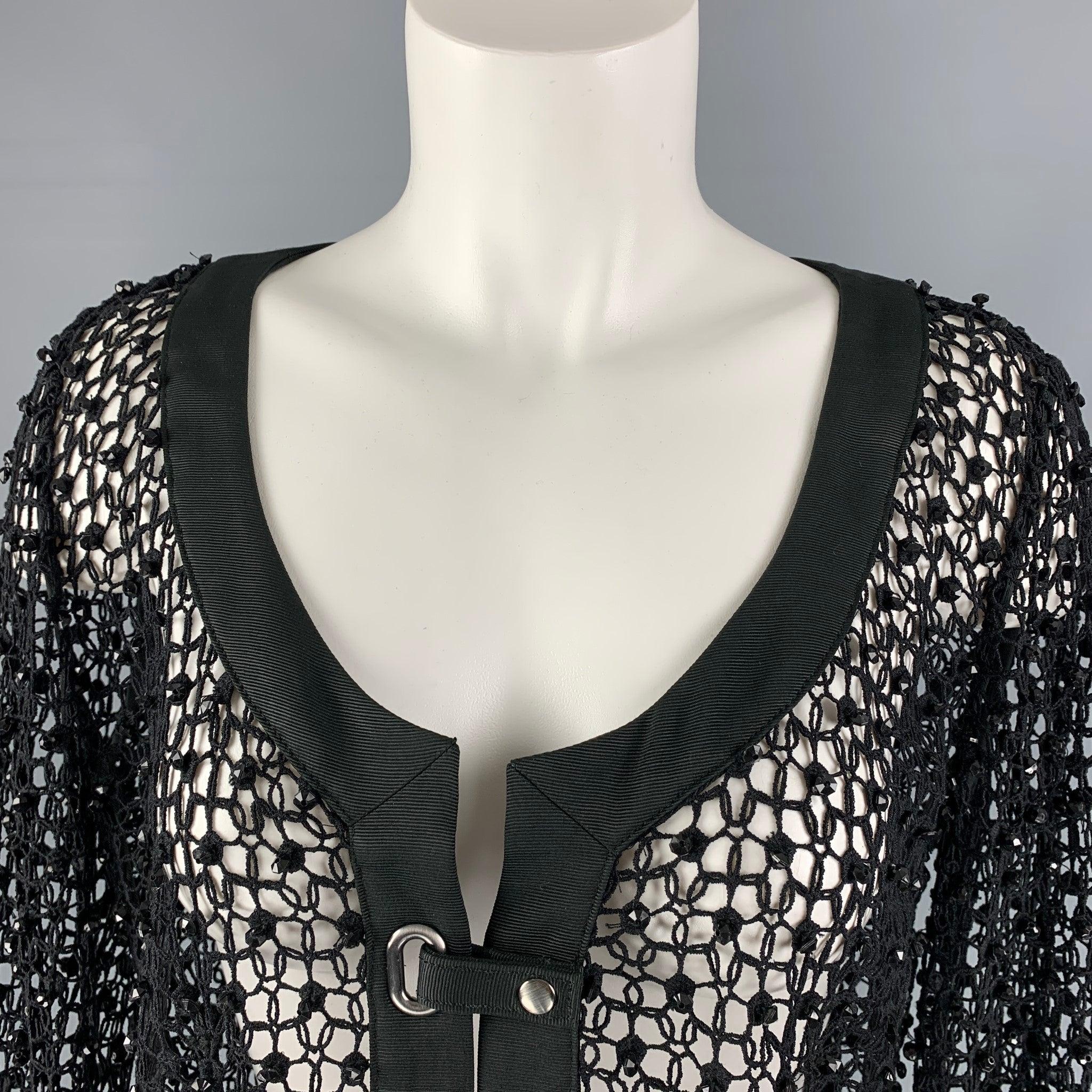 ARMANI COLLEZIONI jacket comes in black mesh fabric, scoop neck, cross over snap button closure and black beaded sequins. Made in Italy.
Excellent Pre-Owned Condition. Fabric Tag Removed. 

Marked:   10 

Measurements: 
 
Shoulder: 15 inches