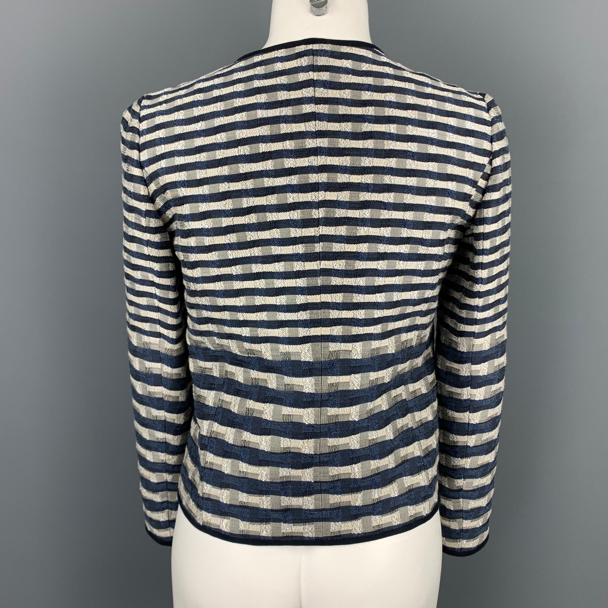 ARMANI COLLEZIONI jacket comes in a navy & white jacquard featuring no collar and a full zip up closure. 

Very Good Pre-Owned Condition.
Marked: 2

Measurements:

Shoulder: 15 in.
Bust: 34 in.
Sleeve: 23 in.
Length: 19.5 in. 