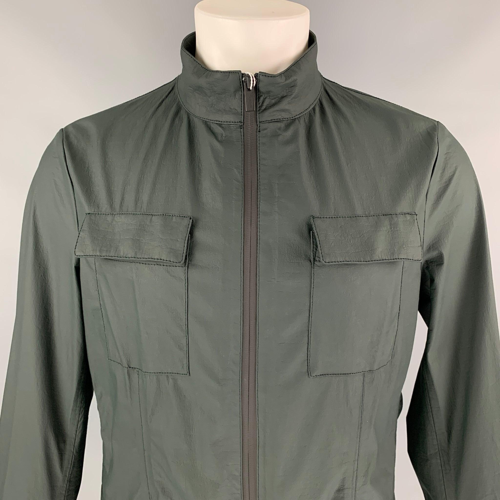 ARMANI COLLEZIONI jacket comes in a dark green polyethylene jacket featuring a water repellent material featuring a high collar, four front pockets, and a zip up closure.
New With Tags.
 

Marked:   48 

Measurements: 
 
Shoulder: 17.5 inches 