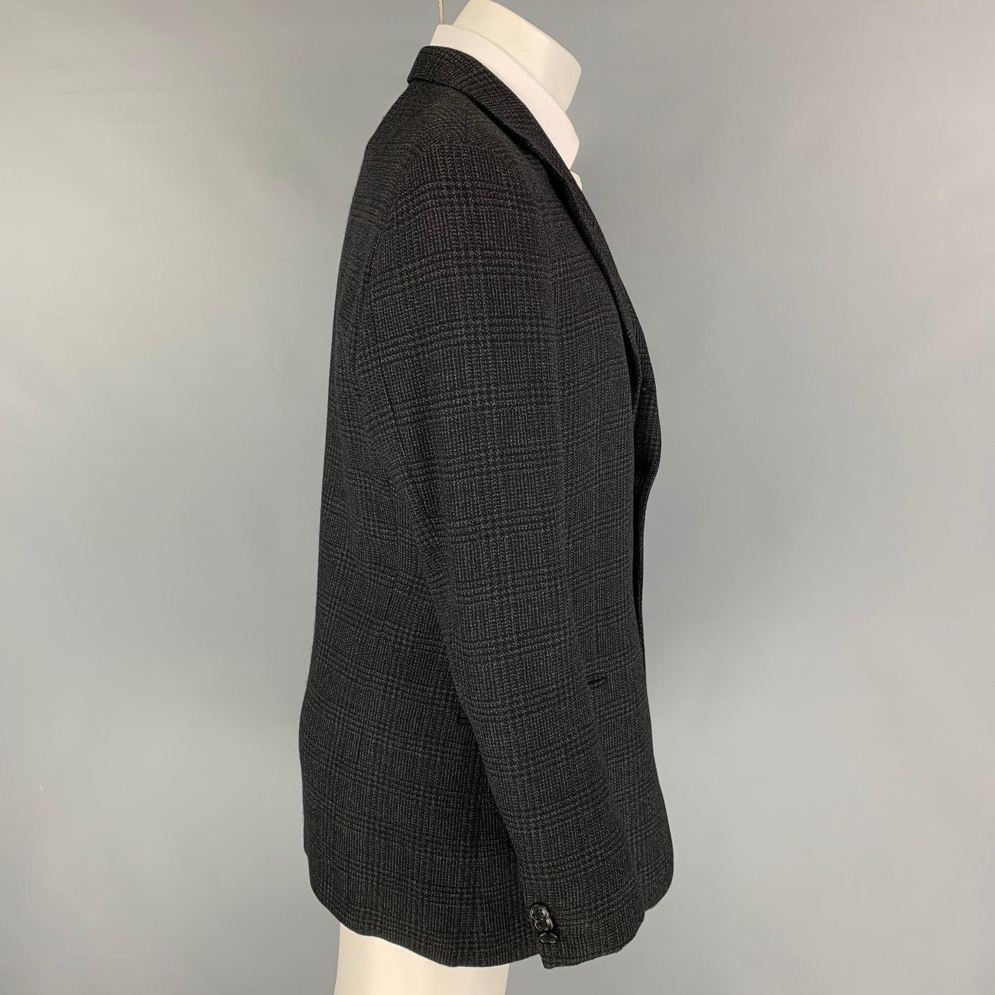 ARMANI COLLEZIONI sport coat comes in a charcoal & black plaid wool with a full liner featuring a notch lapel, slit pockets, and a double button closure.
Very Good
Pre-Owned Condition.  

Marked:   40 

Measurements: 
 
Shoulder: 19 inches  Chest: