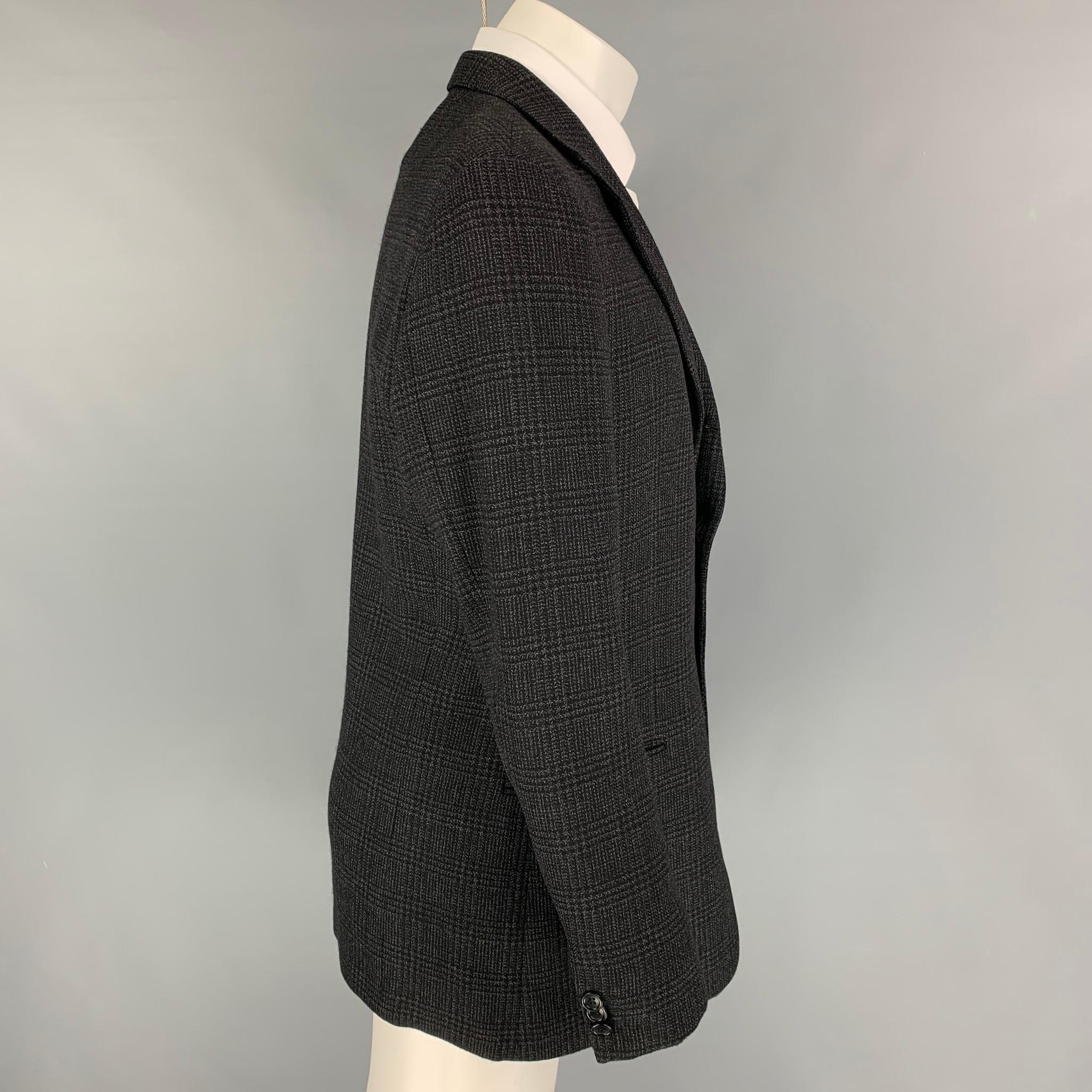 ARMANI COLLEZIONI sport coat comes in a charcoal & black plaid wool with a full liner featuring a notch lapel, slit pockets, and a double button closure. 

Very Good Pre-Owned Condition.
Marked: 40

Measurements:

Shoulder: 19 in.
Chest: 40