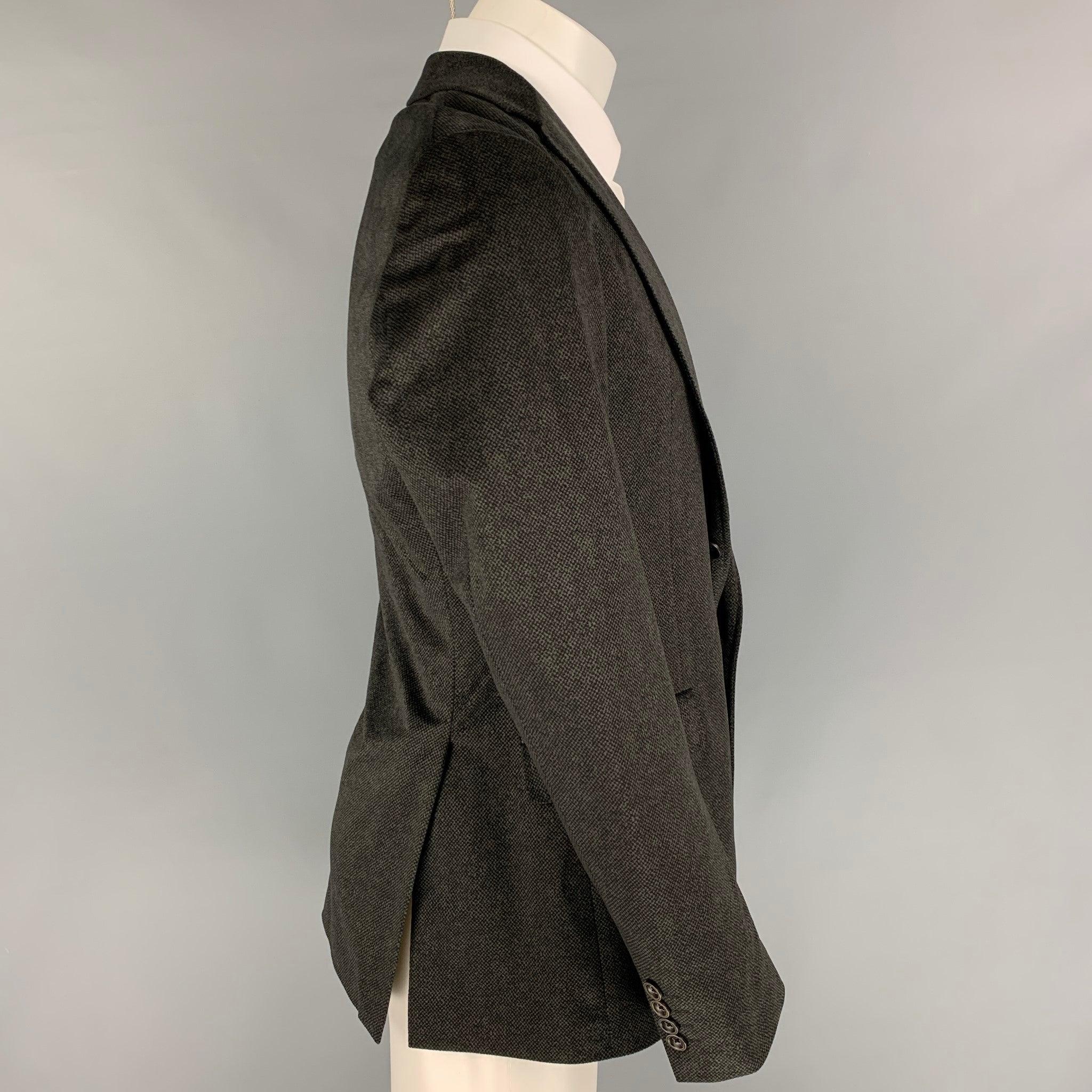 ARMANI COLLEZIONI sport coat comes in a charcoal / black polyester with a full liner featuring a notch lapel, flap pockets, double back vent, and a double button closure.
Very Good
Pre-Owned Condition.  

Marked:   40 

Measurements: 
 
Shoulder: