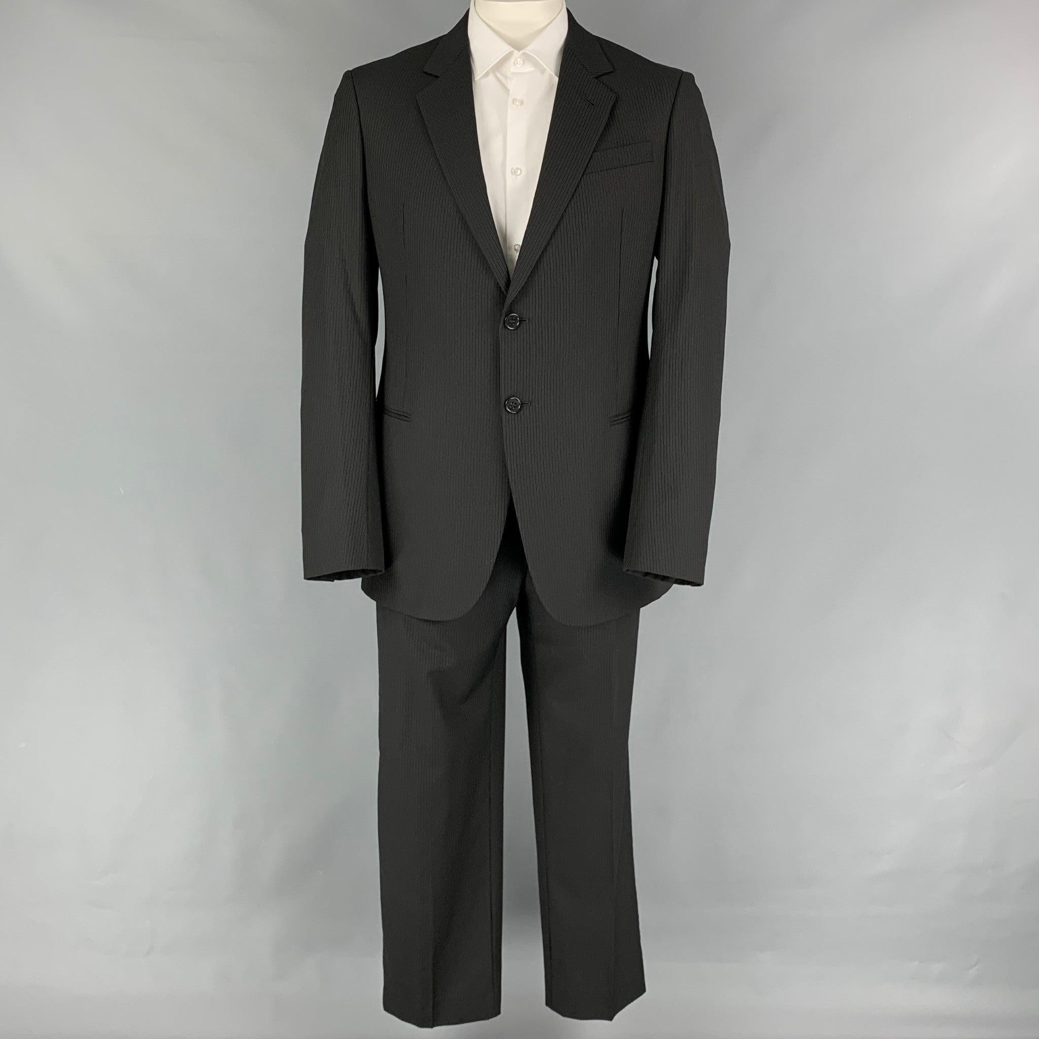ARMANI COLLEZIONI
suit comes in a black pinstripe wool with a full liner and includes a single breasted, two button sport coat with a notch lapel and matching flat front trousers. Very Good Pre-Owned Condition. 

Marked:   42 

Measurements: 
 
