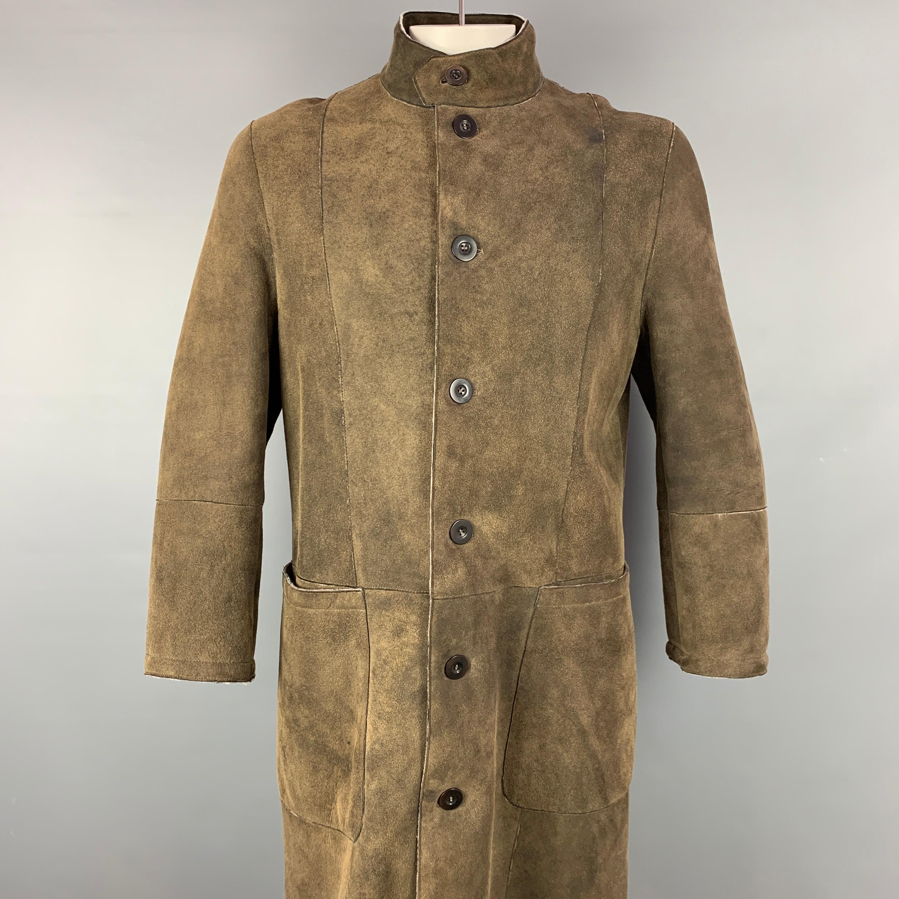 ARMANI COLLEZIONI coat comes in a olive distresses shearling sheepskin with a fur liner featuring a nehru collar, top stitching, front patch pockets, back slit, and a buttoned closure. Made in Italy. 

Very Good Pre-Owned Condition.
Marked:
