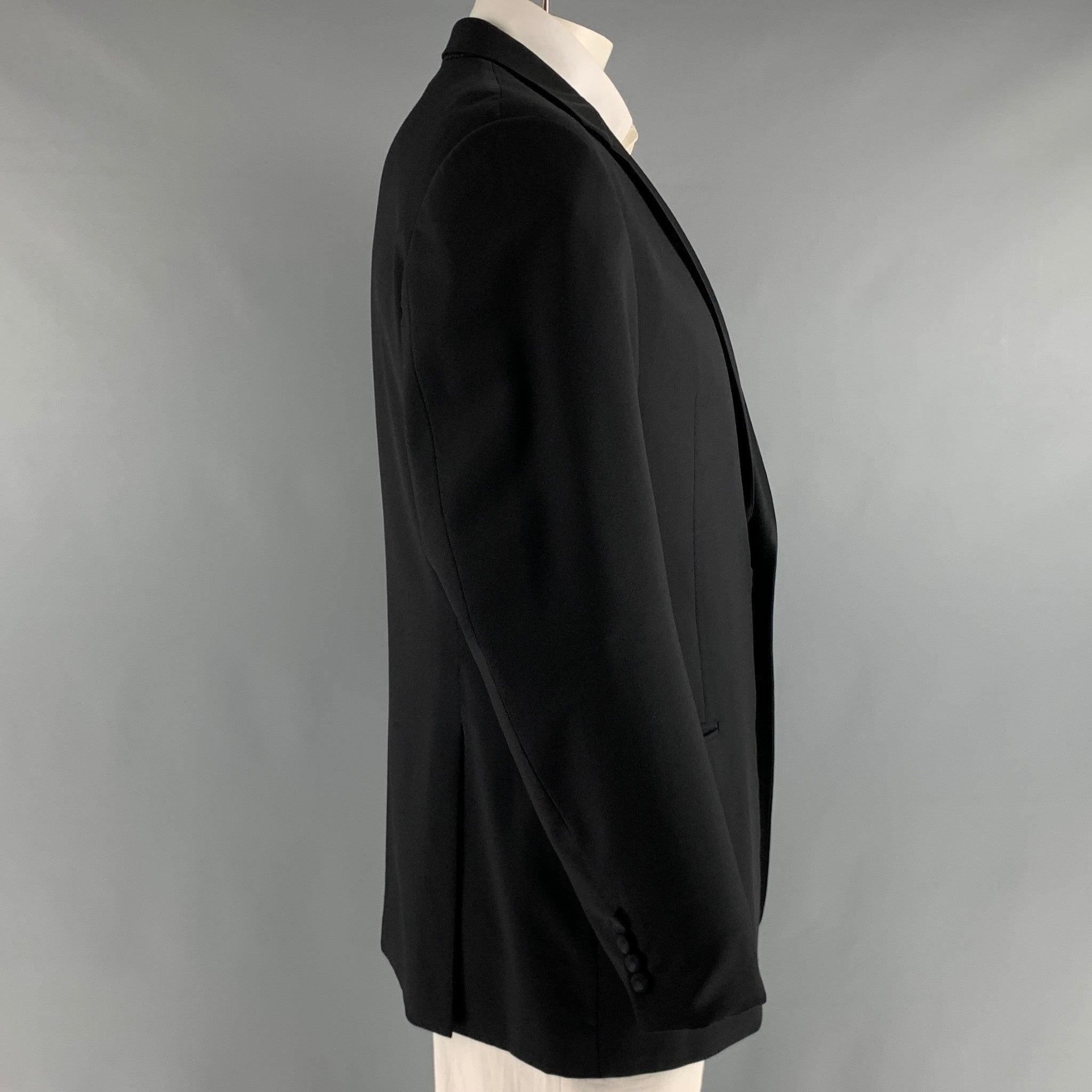 ARMANI COLLEZIONI GIORGIO tuxedo sport coat comes in a black wool woven with a full liner featuring a notch lapel, welt pockets, double back vent, and a single button closure. Made in Italy.Excellent Pre-Owned Condition. 

Marked:   44