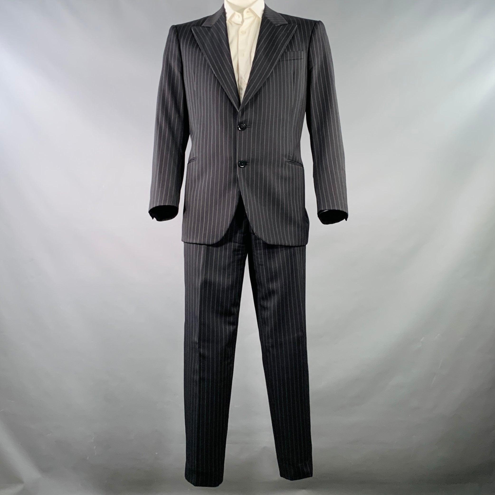 ARMANI COLLEZIONI for SAKS FIFTH AVENUE suit
in a black & white pinstripe wool with a full liner and includes a single breasted, double button sport coat with a peak lapel and matching flat front trousers. Made in Italy.Very Good Pre-Owned