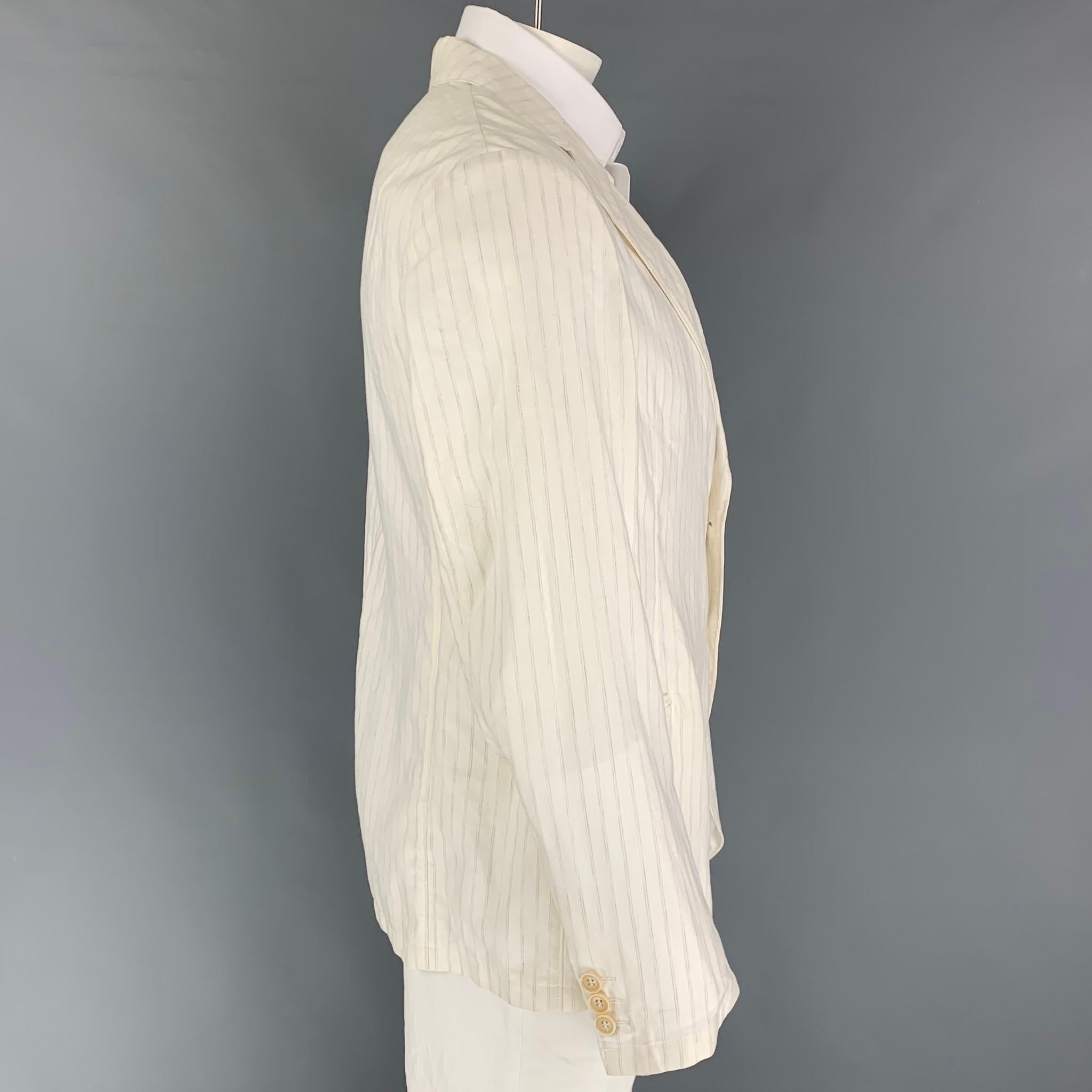 ARMANI COLLEZIONI sport coat comes in a off white stripe cotton / linen featuring a notch lapel, slit pockets, and a double button closure. 

Good Pre-Owned Condition.
Marked: 44

Measurements:

Shoulder: 18.5 in.
Chest: 44 in.
Sleeve: 27