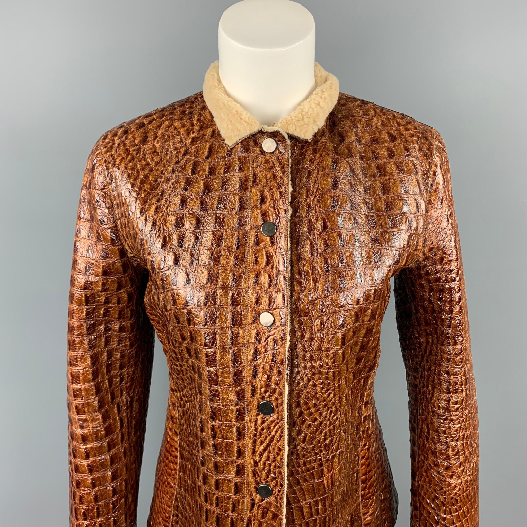 ARMANI COLLEZIONI jacket comes in a brown embossed leather wit a fur liner featuring a collar and a snap button closure. Made in Italy.

Very Good Pre-Owned Condition.
Marked: IT 40

Measurements:

Shoulder: 16 in.
Bust: 34 in.
Waist: 32 in.
Sleeve: