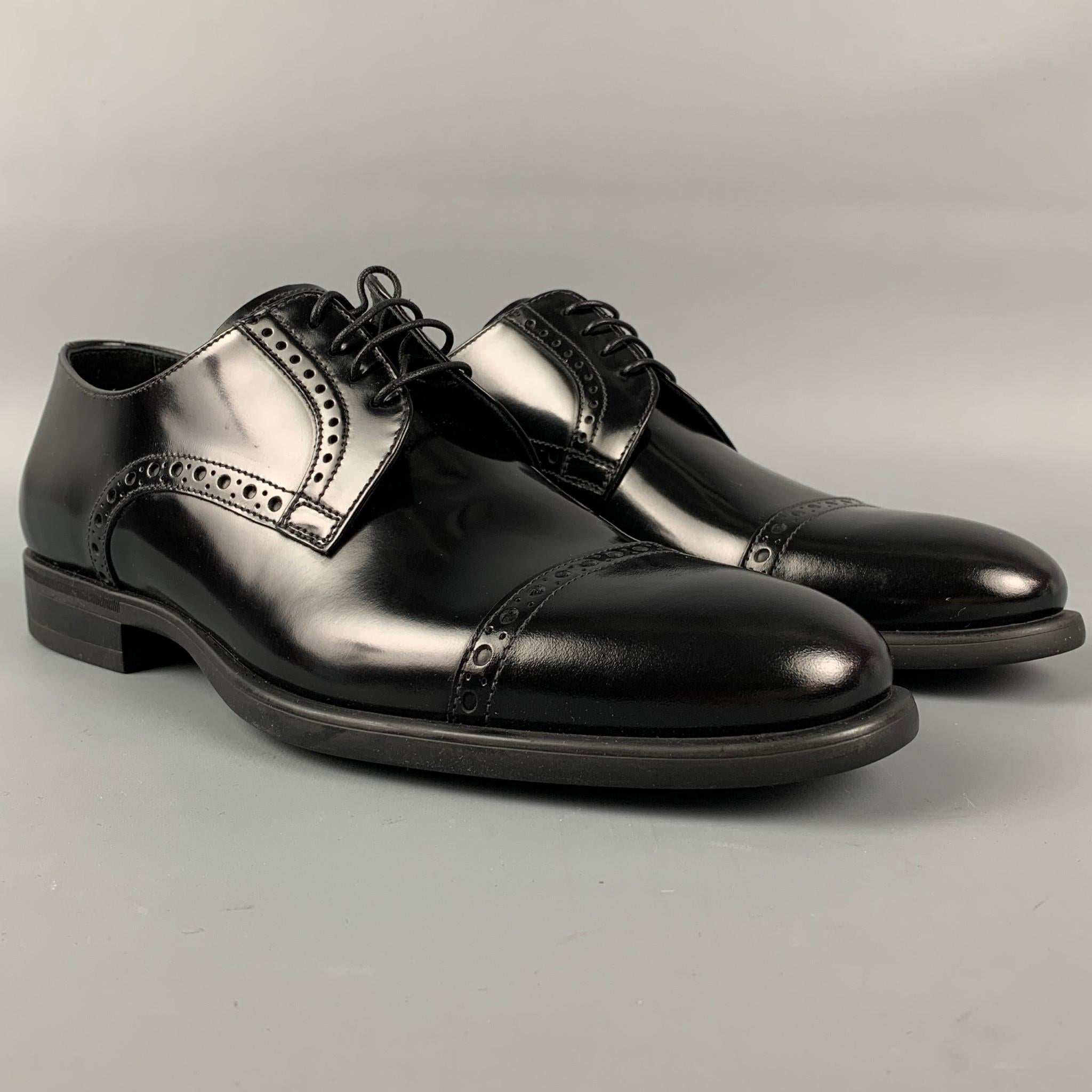 ARMANI COLLEZIONI shoes comes in a black perforated patent leather featuring a cap toe, stacked heel, and a lace up closure. 

New With Box. 
Marked: X6C052 41

Outsole: 11.5 in. x 4 in. 
SKU: 111470
Category: Lace Up Shoes

More Details
Brand: