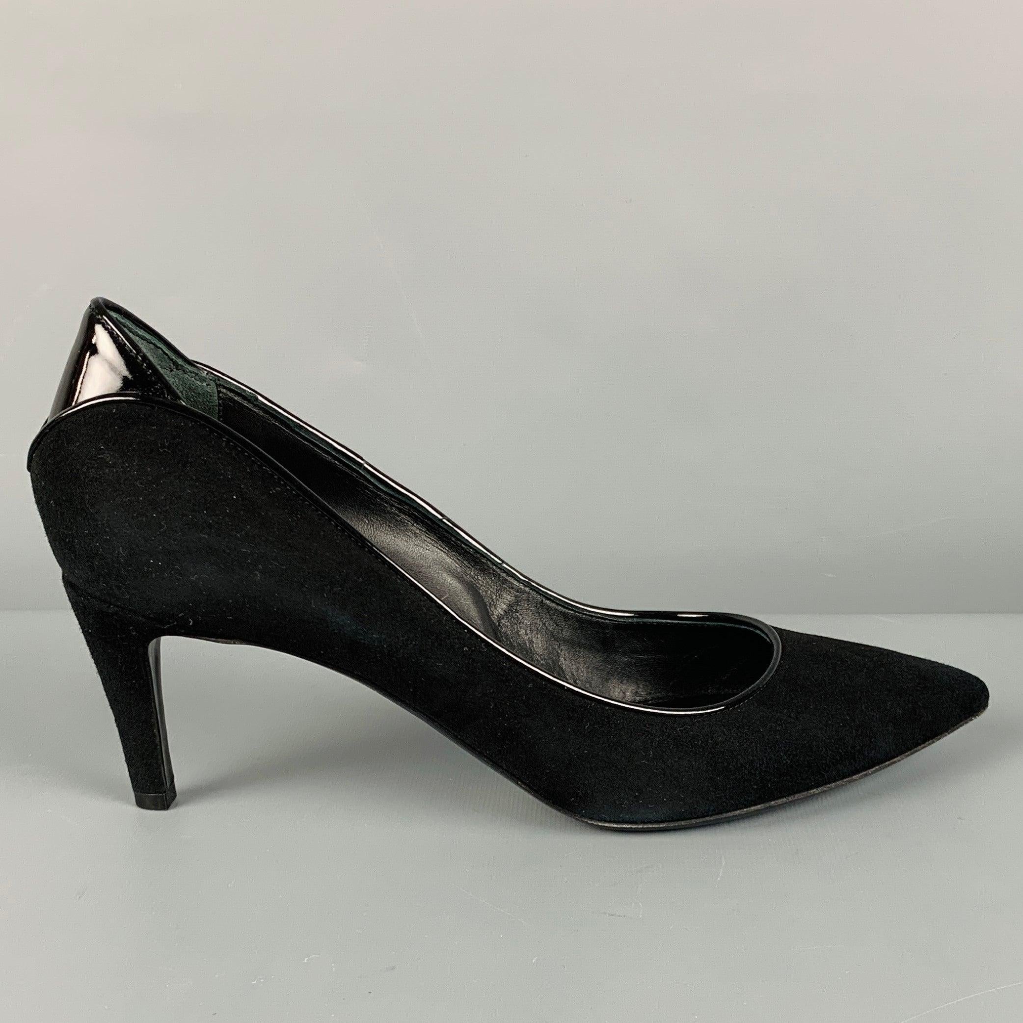 ARMANI COLLEZIONI pumps
in black suede fabric featuring a classic pump style, patent leather trim and heel details, and pointed toe. Comes with box. Made in Italy.Excellent Pre-Owned Condition. 

Marked:   39.5 

Measurements: 
  Heel: 2.75 inches 
