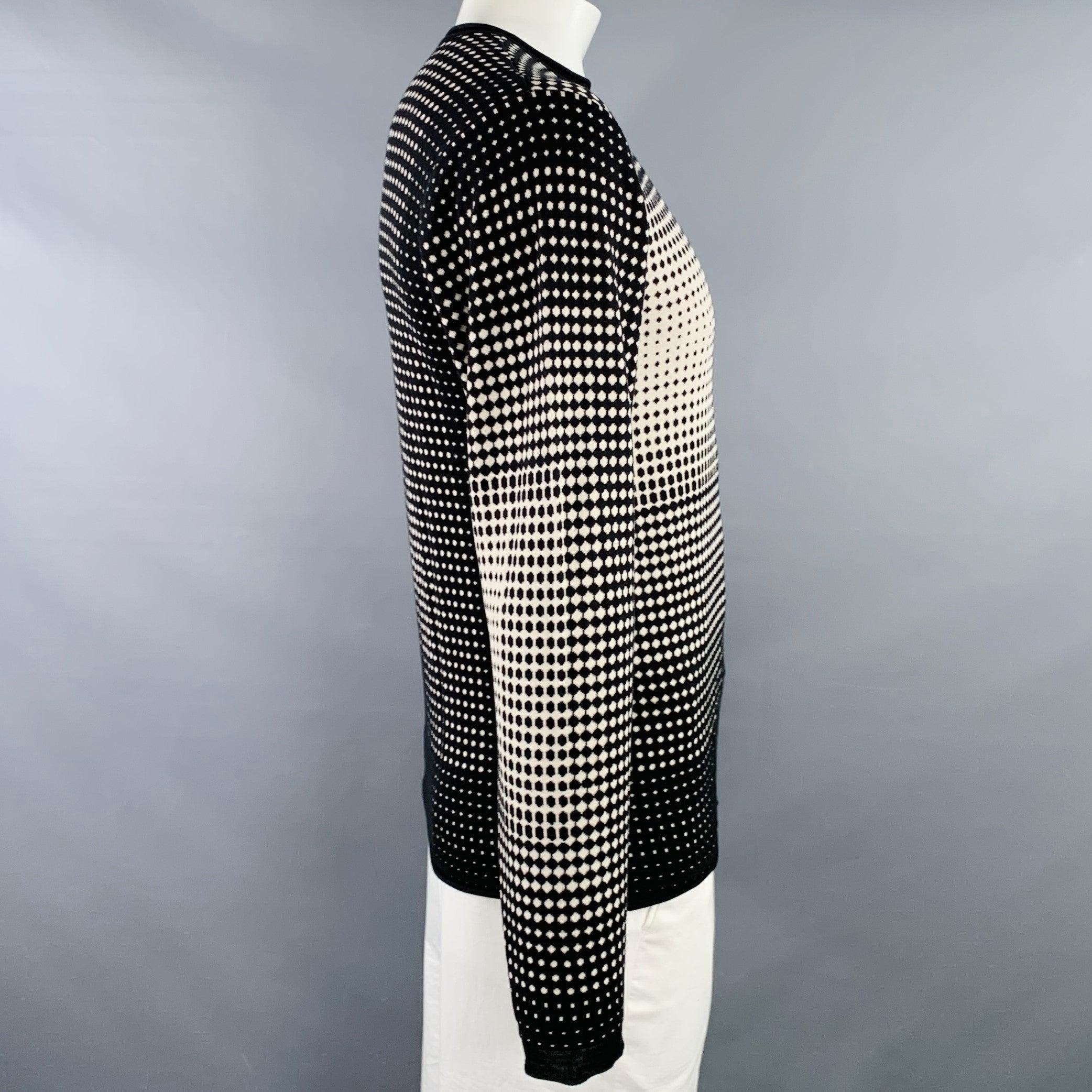 ARMANI COLLEZIONI pullover
in a black and white silk blend knit featuring a geometric pattern with all over dots, long sleeves, and crew neck. Very Good Pre-Owned Condition. Multiple minor marks, which are hidden partially by pattern. 

Marked:   L