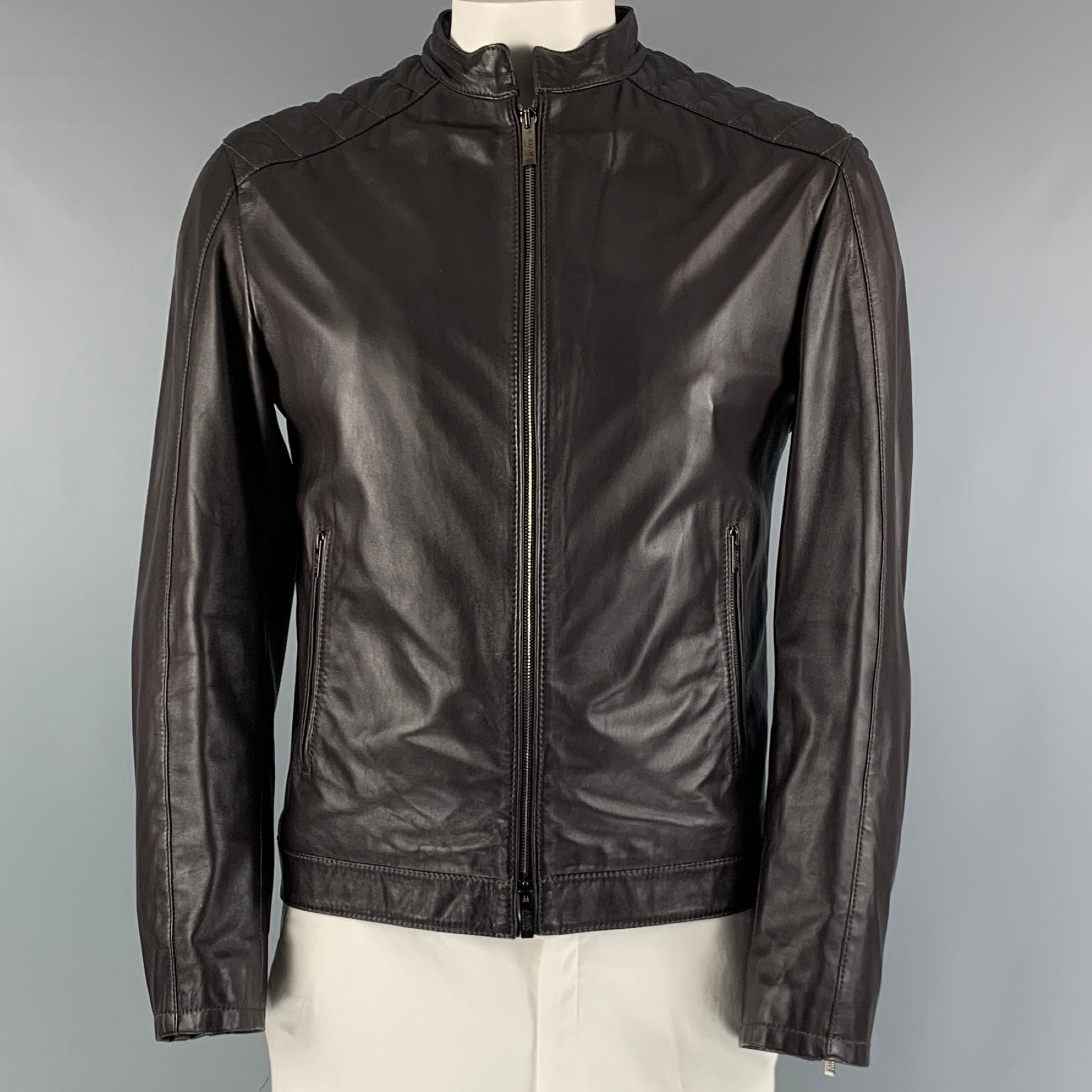 ARMANI COLLEZIONI motorcycle jacket comes in a brown leather material featuring a quilted texture at shoulder, mandarin collar, zip cuffs, zip pockets, and a zip up closure.

Excellent Pre-Owned Condition.
Marked: 42

Measurements:

Shoulder: 19