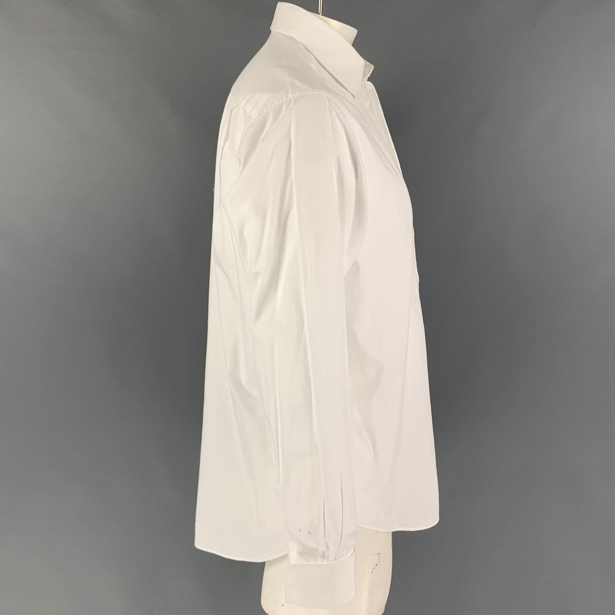 ARMANI COLLEZIONI tuxedo long sleeve shirt comes in a white cotton featuring french cuffs, spread collar, and a hidden placket closure. Made in Italy.
 Good
 Pre-Owned Condition. Small marks at right sleeve. As-Is.  
 

 Marked:  15.5/39 
 

