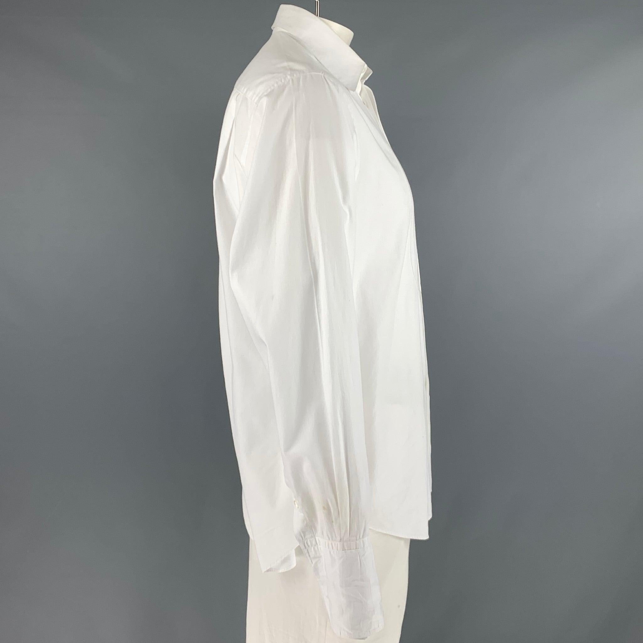 ARMANI COLLEZIONI tuxedo long sleeve shirt comes in a white cotton featuring french cuffs, spread collar, and a hidden placket closure. Made in Italy.
Good Pre-Owned Condition. Small marks at right sleeve, underarms, and collar. As-Is.  

Marked:  