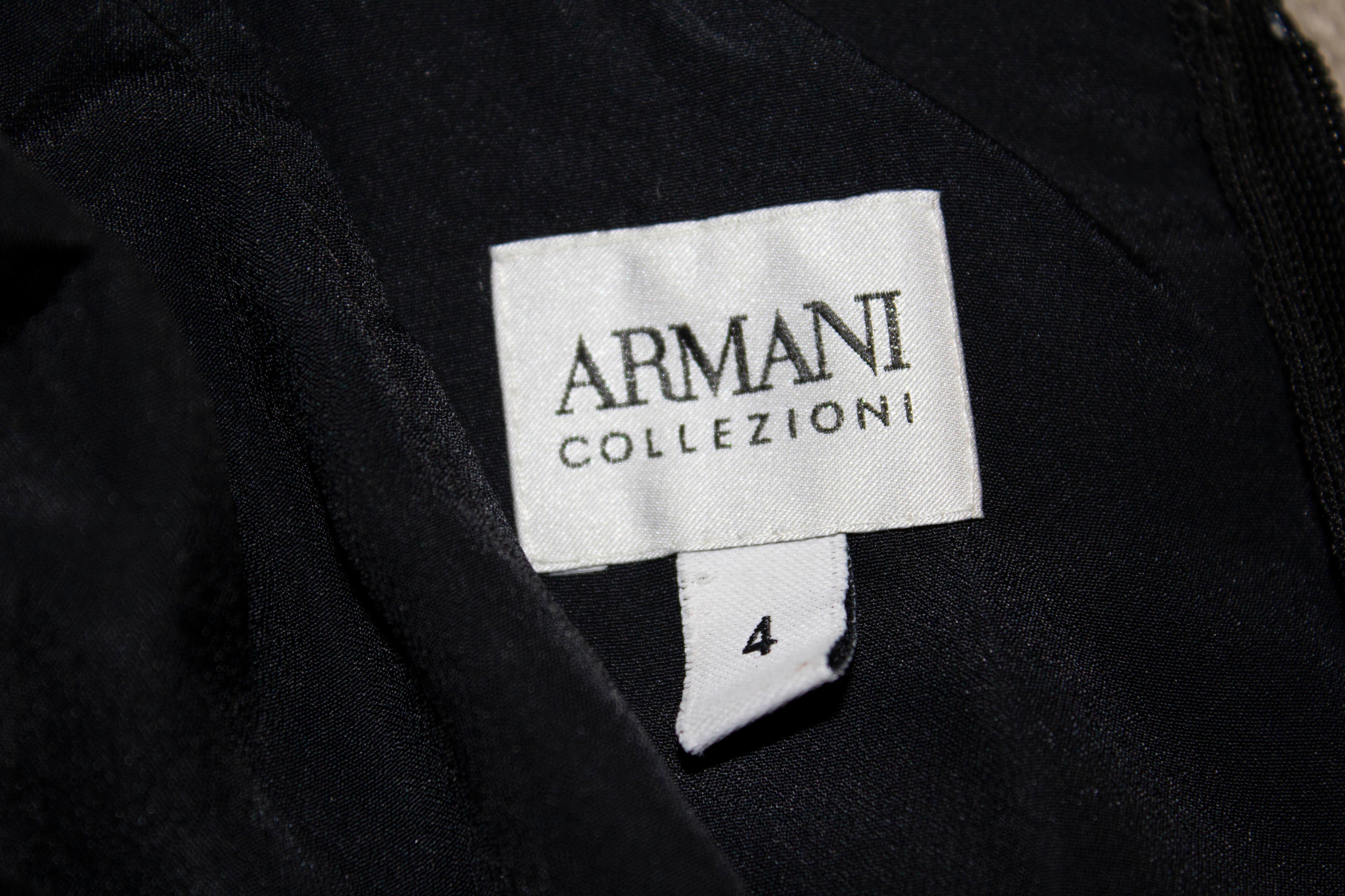 A chic black cocktail dress by Armani Collezzioni, The dress has a pleated skirt area and bust with stitching and deicoration around the neckline.  Size 4  Bust 34'', waist 29'' length 41''