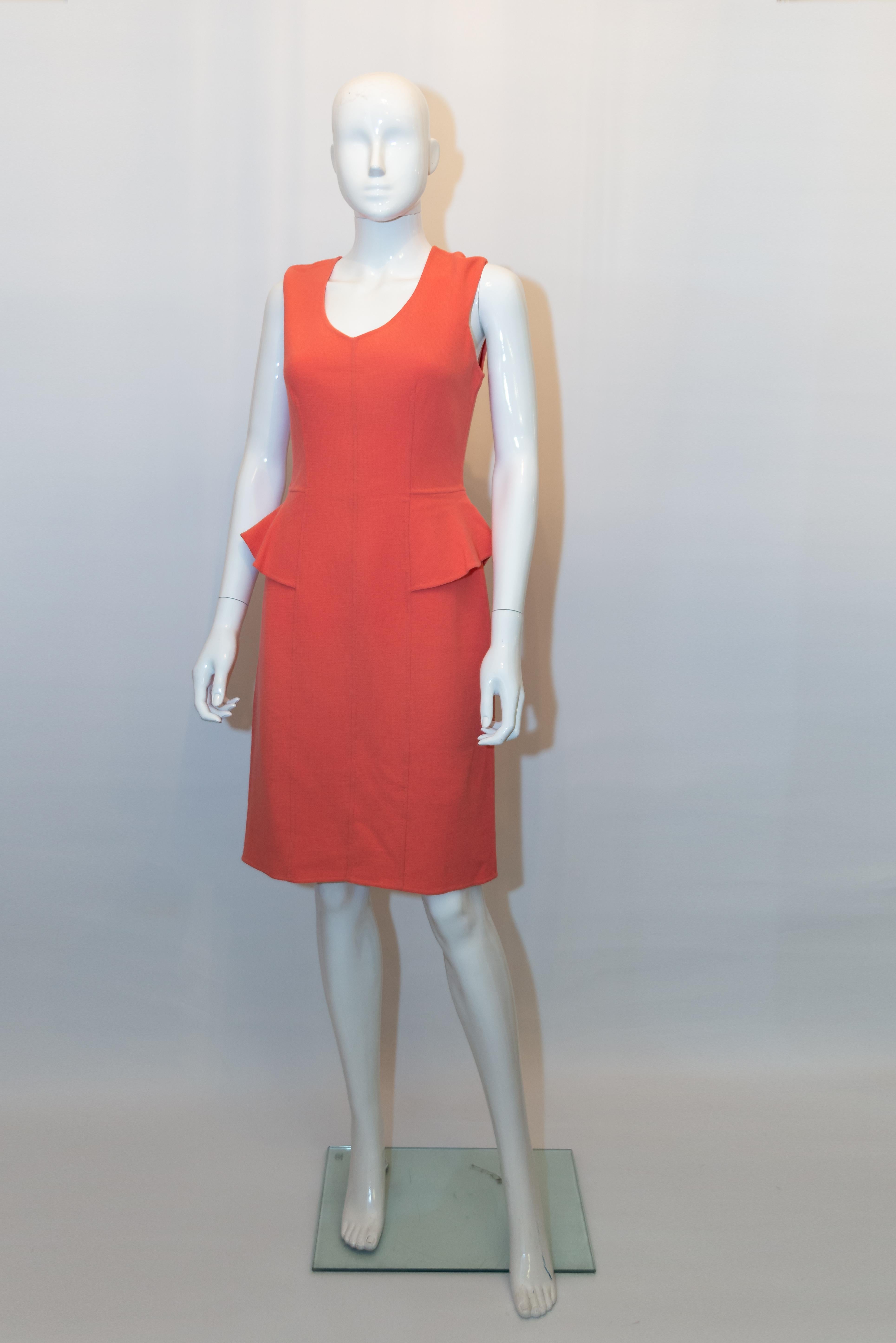 A pretty wool dress by Armani Collezioni.  The dress is in wool with a scoop neckine, back central zip and peplum detail. It is unlined. Size 42 , US 6.
