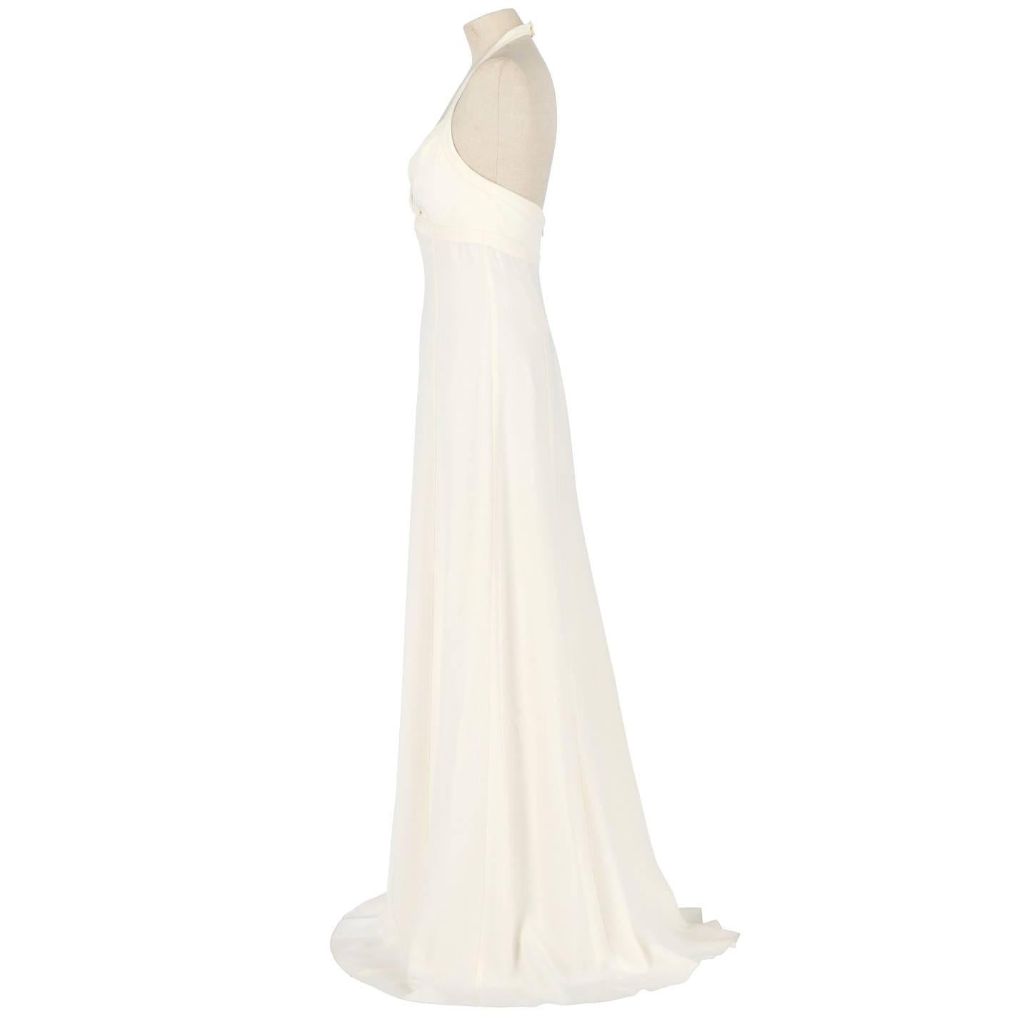 Marvelous Armani silk and acetate wedding dress in ivory white color. It features a V neckline top, shoulder straps fastened behind the neck and is backless. Zip closure on the back. The item comes with its original tag. It is vintage, it was