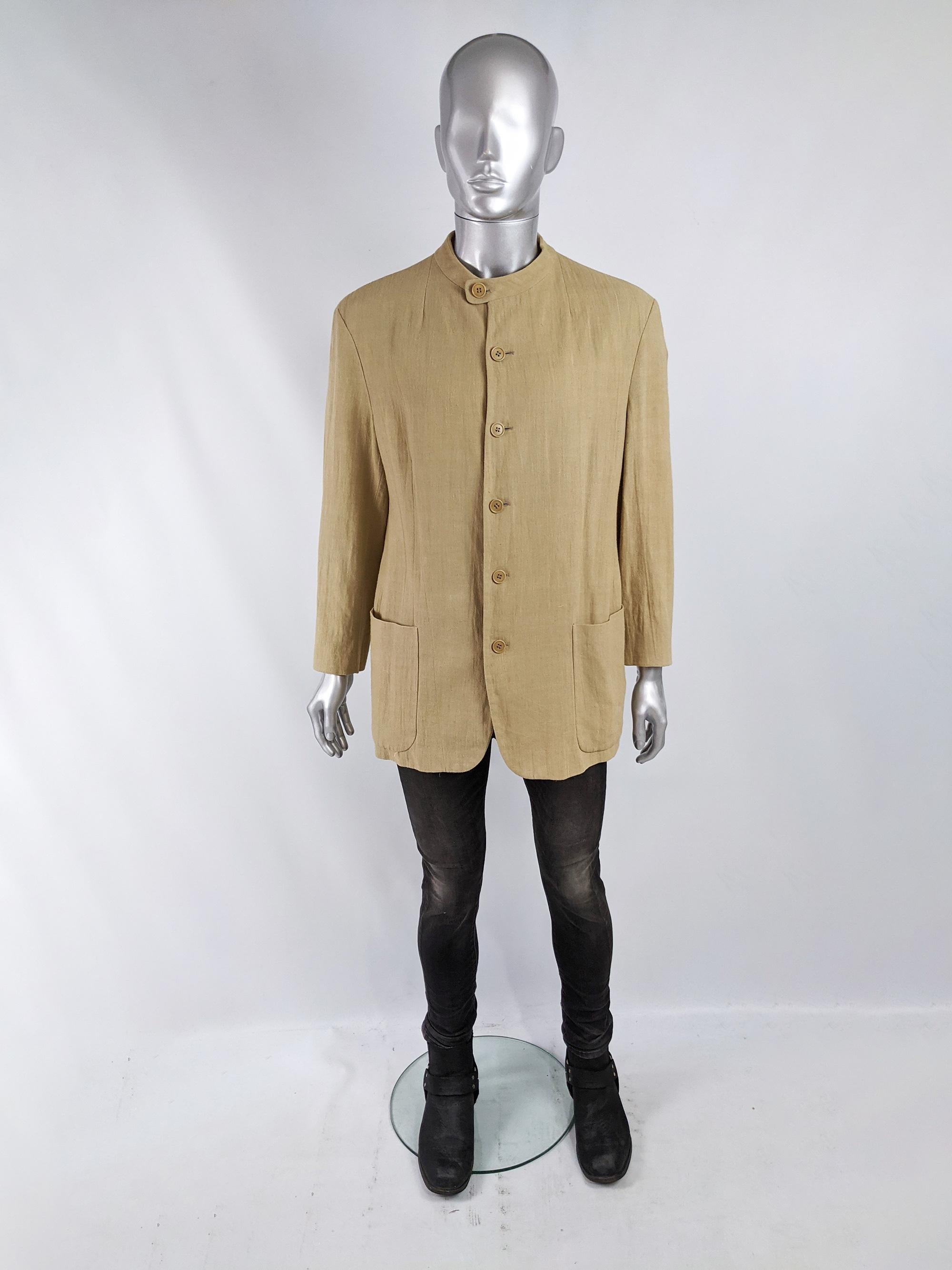 A stylish vintage mens minimalist blazer jacket by Giorgio Armani for the Emporio Armani line. In a beige coloured woven viscose jacket with a collarless / nehru style collar that fastens with a button at one side.  

Size: Marked 50R which equates