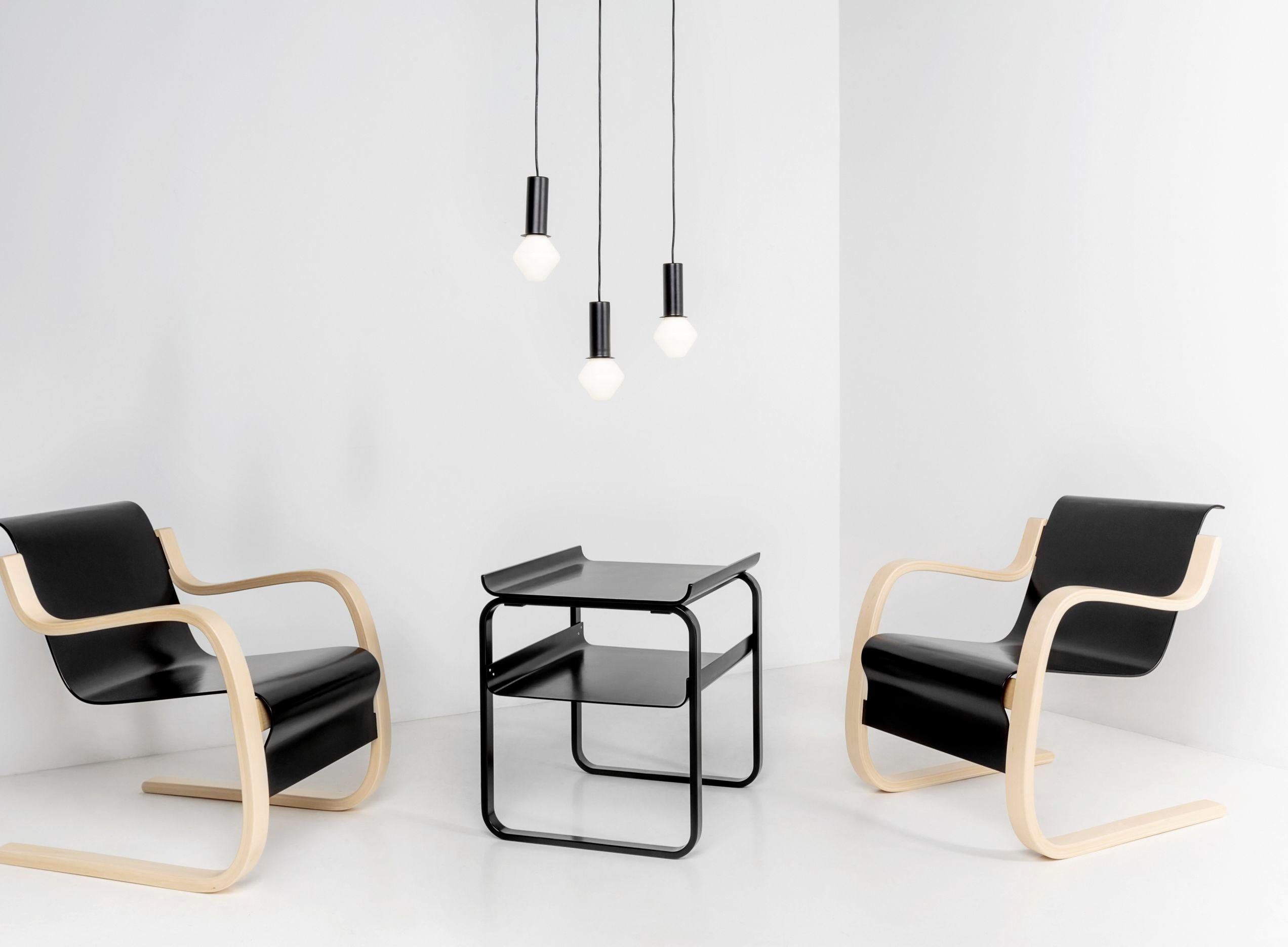 Armchair 42 in birch and black by Alvar Aalto & Artek. Armchair 42 – or “Small Paimio” – was designed by Alvar Aalto for the Paimio Sanatorium in 1932. The frame is made from laminated birch shaped to produce a cantilevered chair; the seat and back