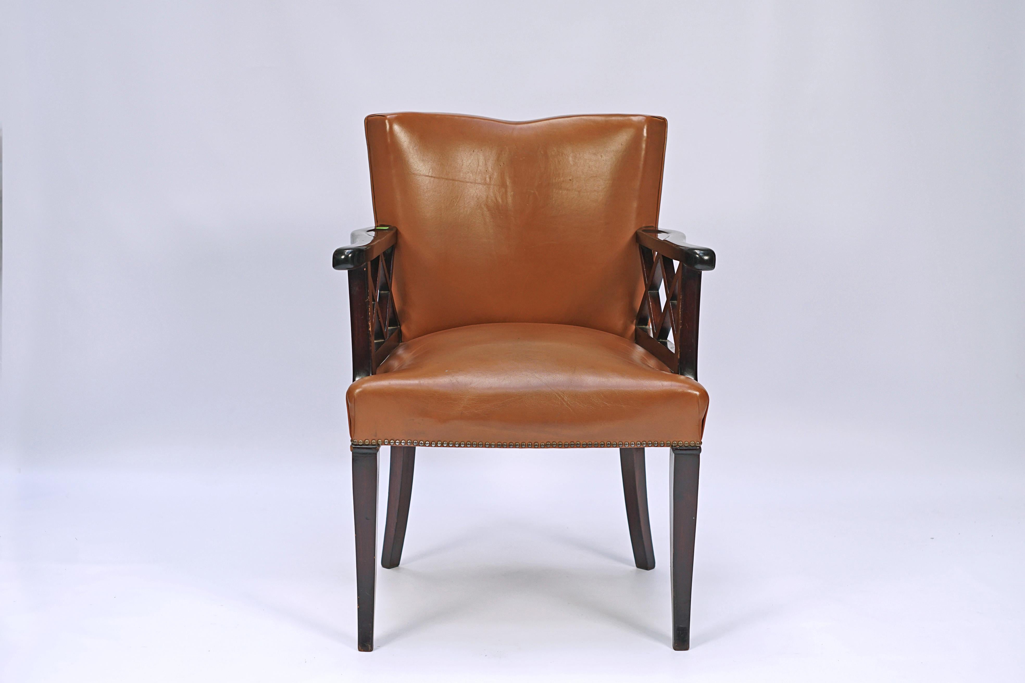 Art Deco armchair made of mahogany wood and leather upholstery.

France, circa 1940.