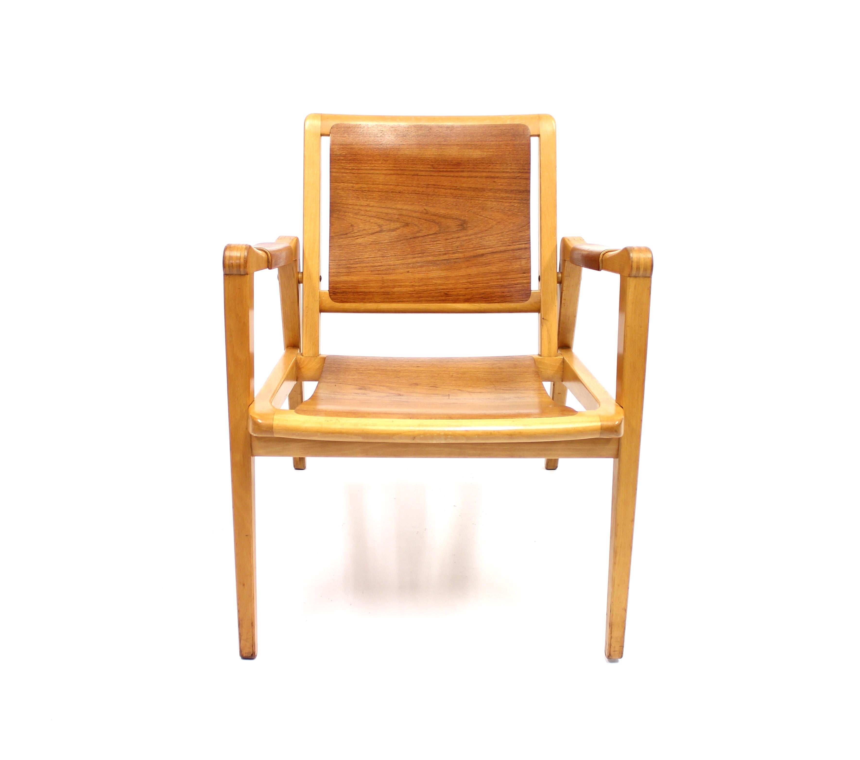 Wonderful midcentury arm chair by Axel Larsson for Bodafors that displays a nice way for the dark teak and the blond beech to coexist. Very good condition with minor ware consistent with age and use.