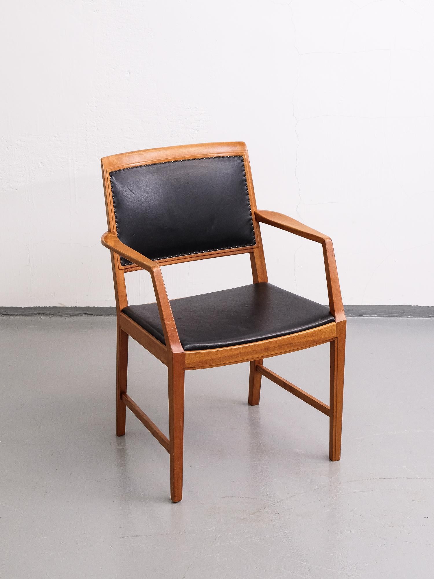 Armhair by Bertil Fridhagen, manufactured by Bodafors, 1950s. Upholstered with black leather, attached with decorative nails on the backrests. Original leather with patina.