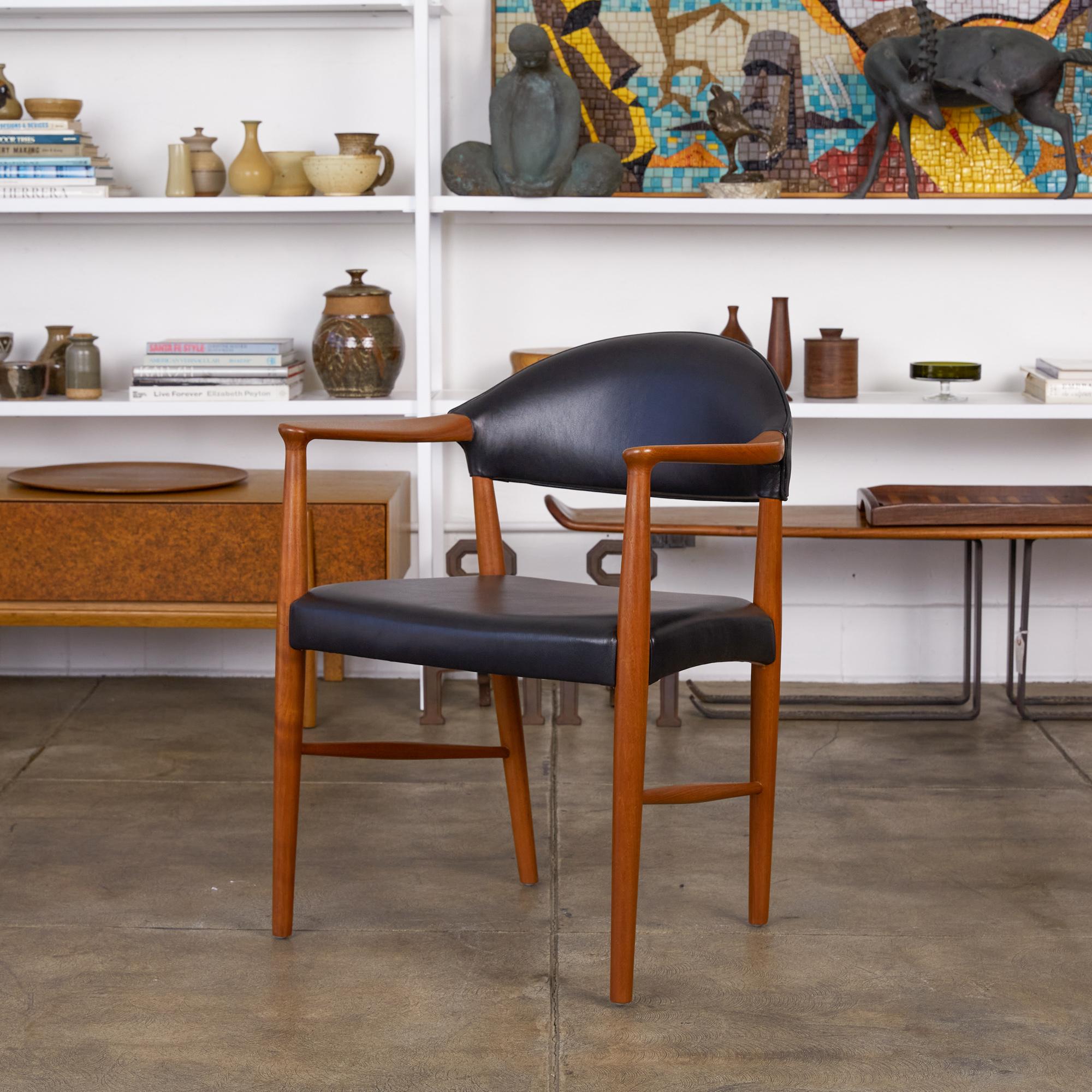 Teak and leather armchair by Ejnar Larsen and A. (Aksel) Bender Madsen for Willy Beck, Denmark, circa 1950s. The chair features a fully upholstered seat and backrest in a supple black leather. The sculpted armrests and legs are made from teak. The