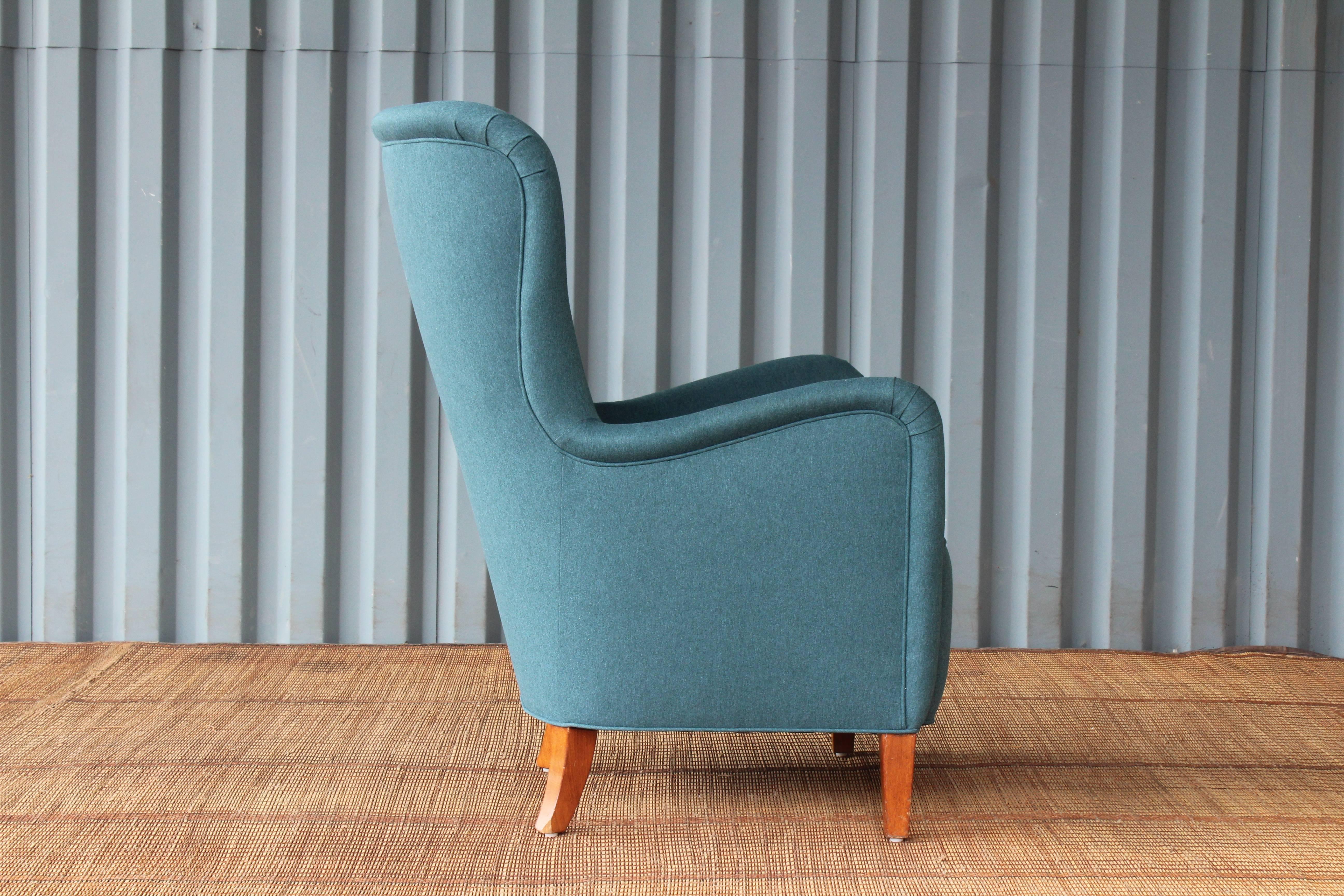 Early Modern armchair designed by Ernest Race, 1940s, England. Recently upholstered in a beautiful dark teal fabric. His and her pair available.